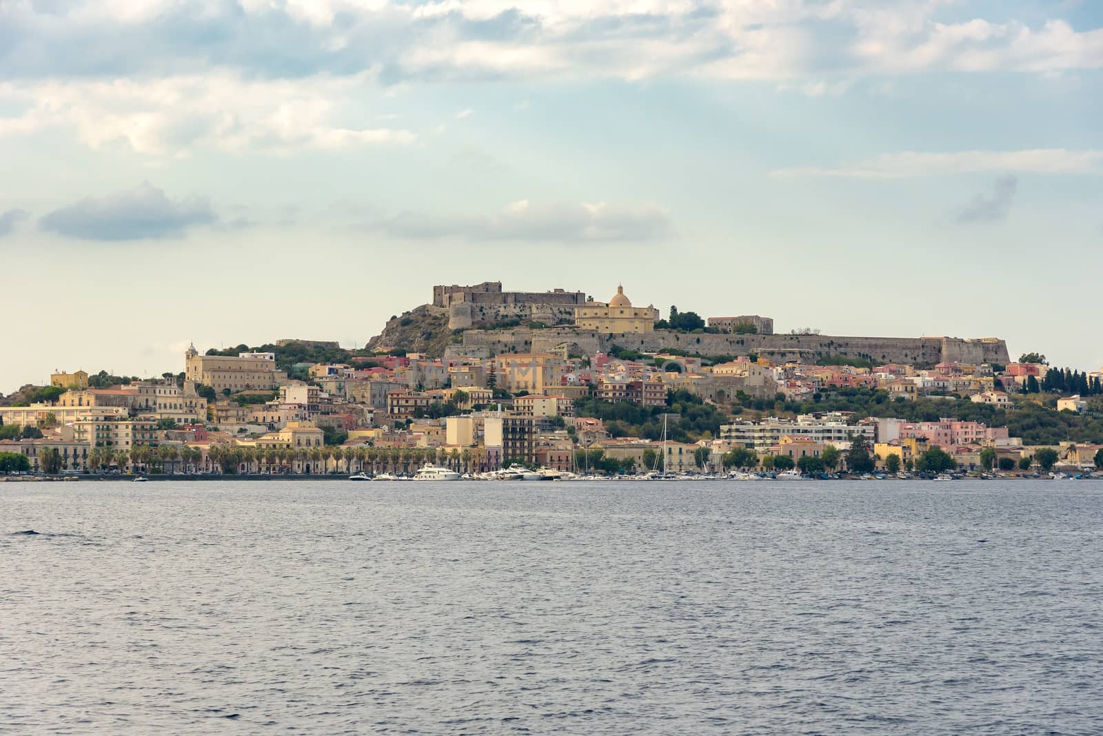 View of Milazzo town from the sea at sunset, Sicily, Italy