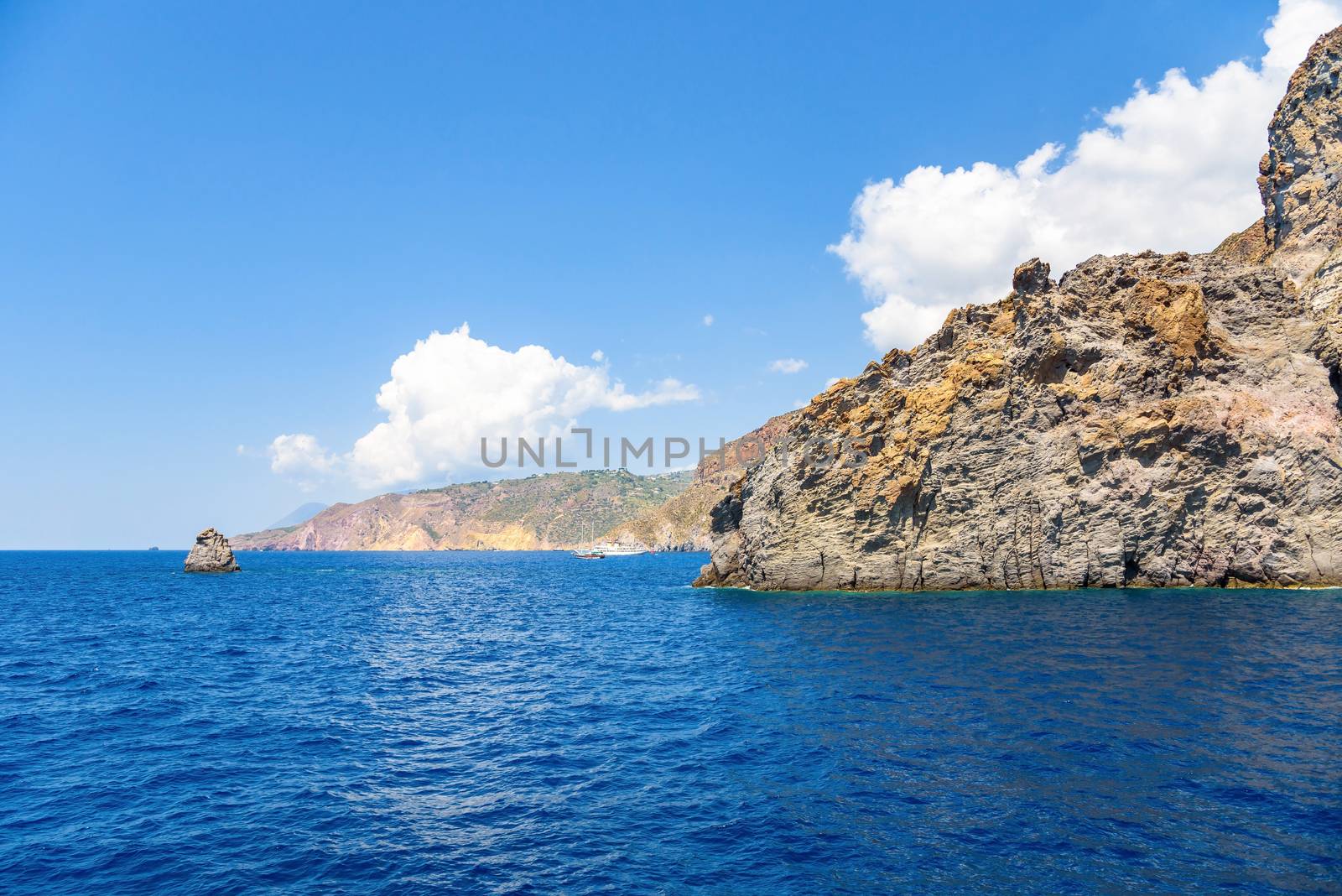 Rocky cliff coast of the Lipari Island seen from the sea, Aeolian Islands, Italy