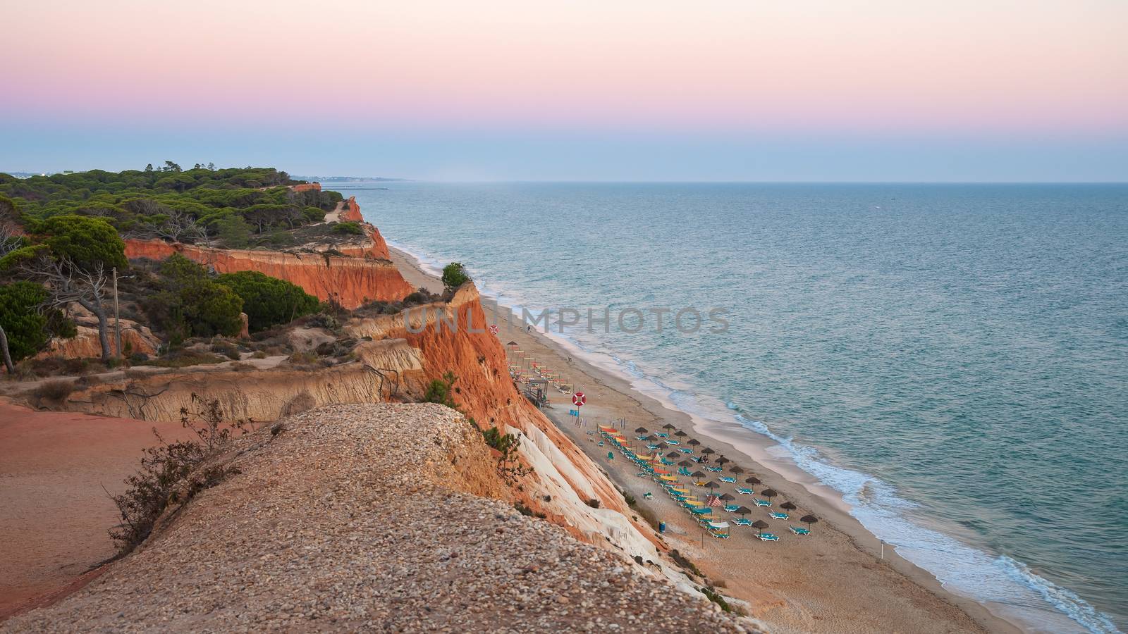 Beautiful Falesia Beach in Portugal seen from the cliff at dusk. Algarve, Portugal