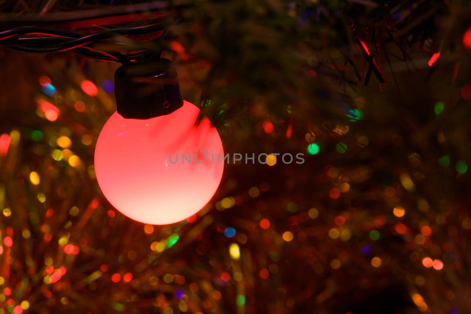 Closeup of red Christmas tree lamp as background