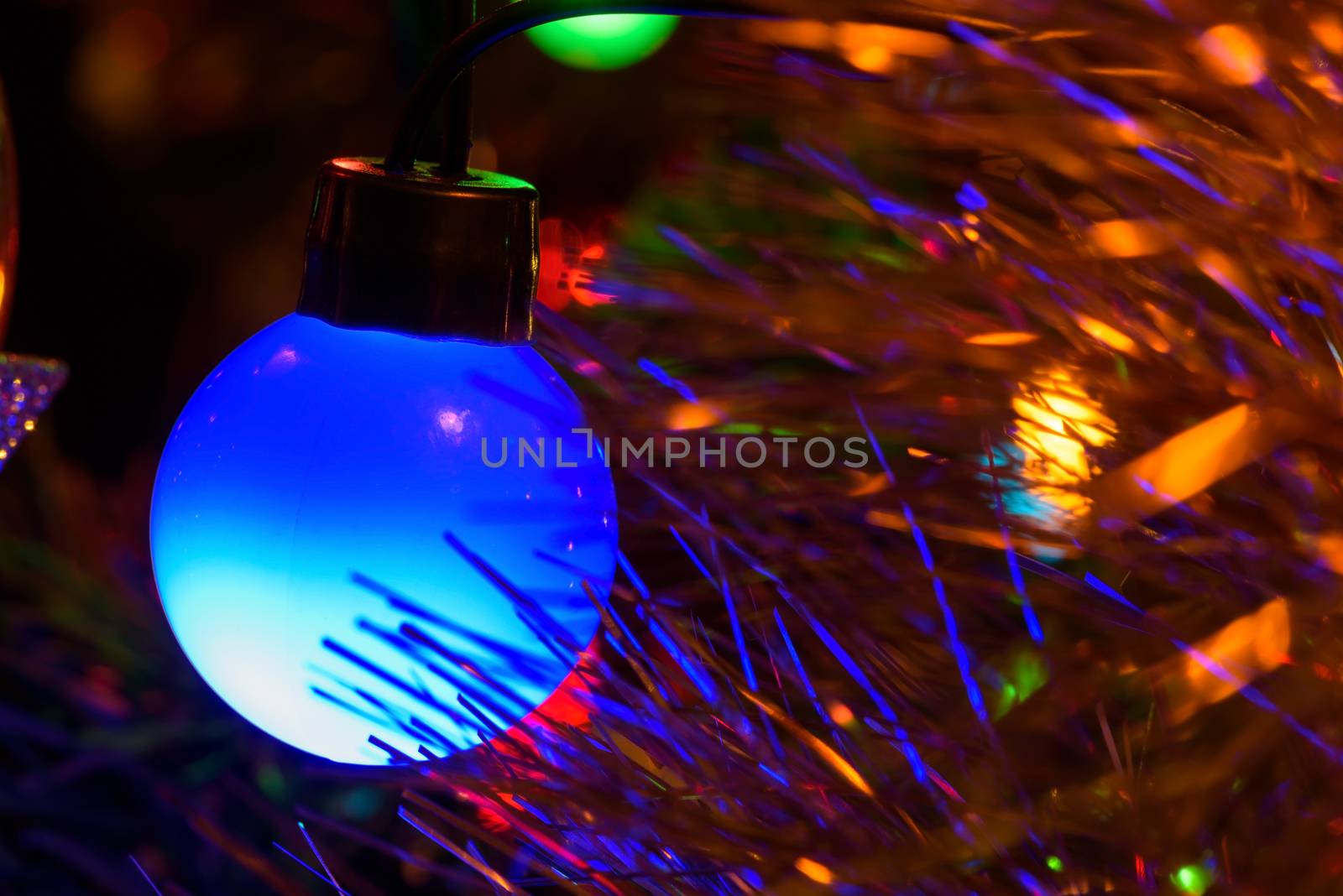 Closeup of blue Christmas tree lamp as background