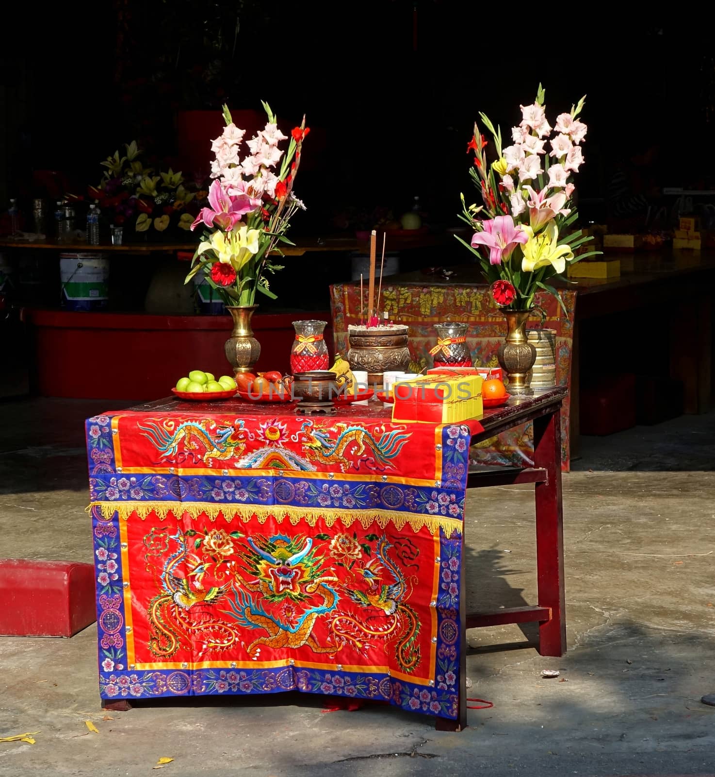An altar with flowers, fruits, incense and ghost money in Taiwan