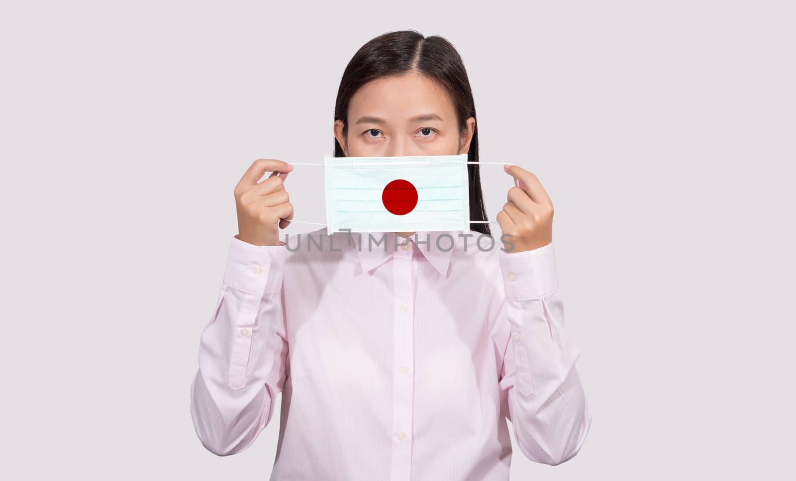 Asian woman wearing hygienic face mask painting Japan flag to pr by asiandelight