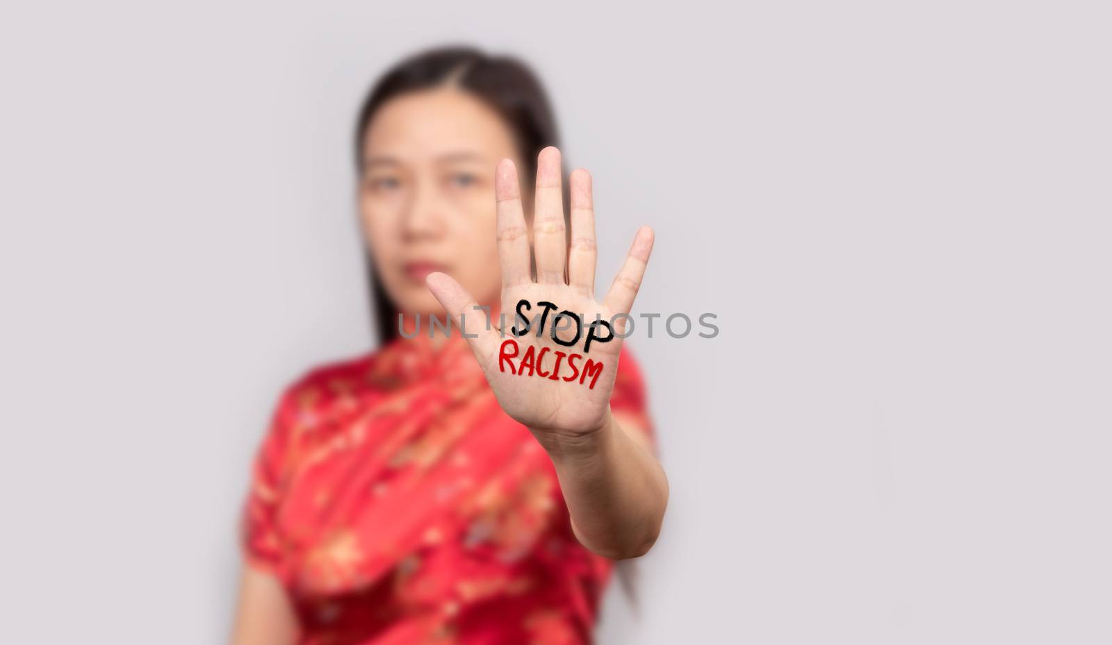 Asian woman in Chinese costume doing stop gesture with palm hand by asiandelight