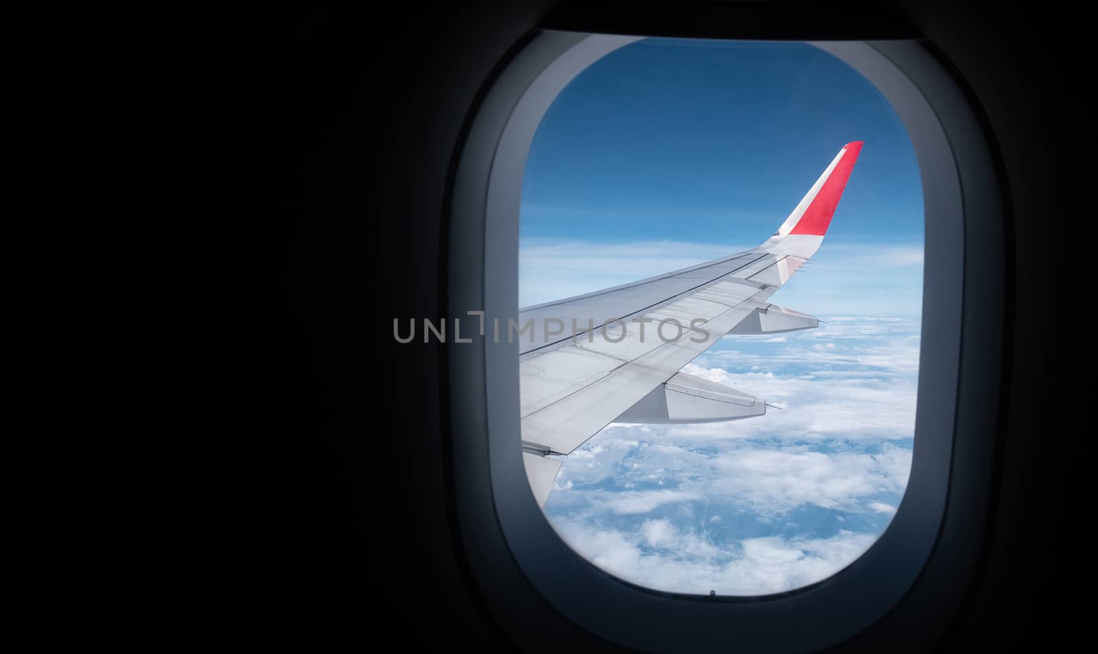 beautiful aerial view of the sky from the plane window while traveling by plane with copy space for travel advertising banner