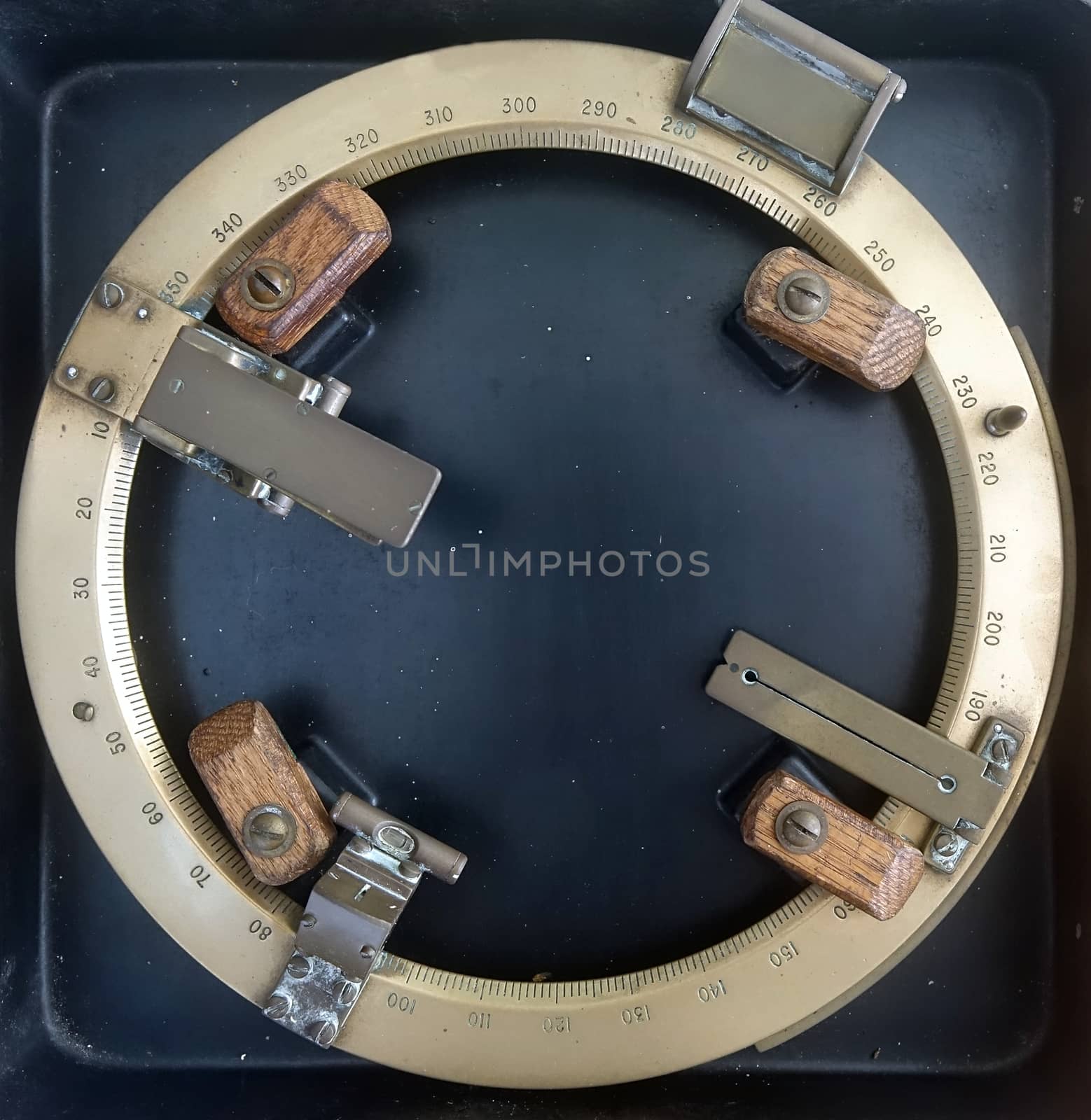 A vintage azimuth circle made from brass and used for ship navigation
