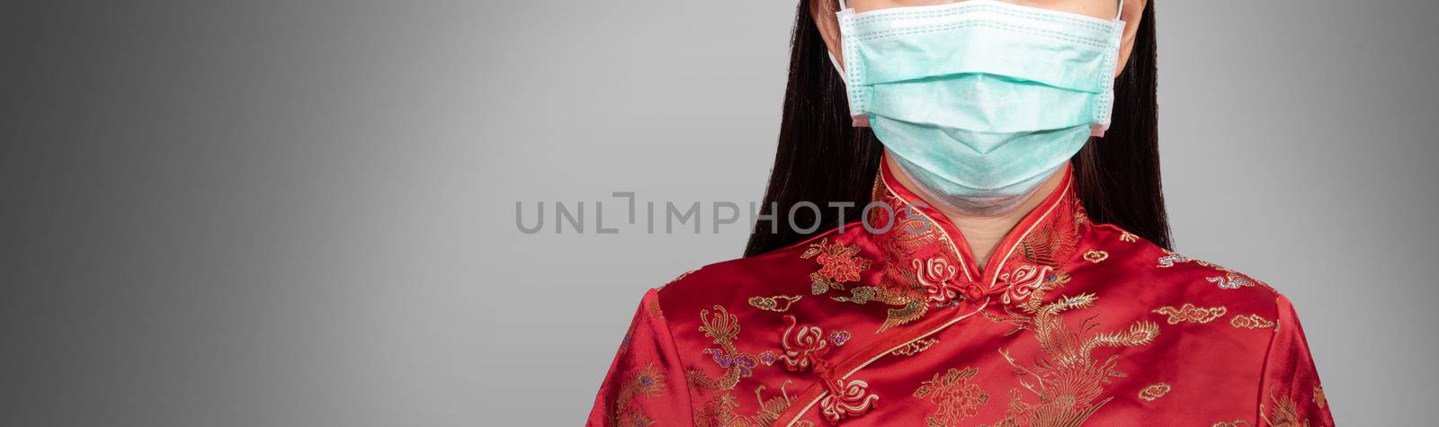 Asian woman in Chinese costume wear a hygienic mask with copy space, anonymous face. the outbreak situation of Coronavirus 2019 infection or Covid-19 concept