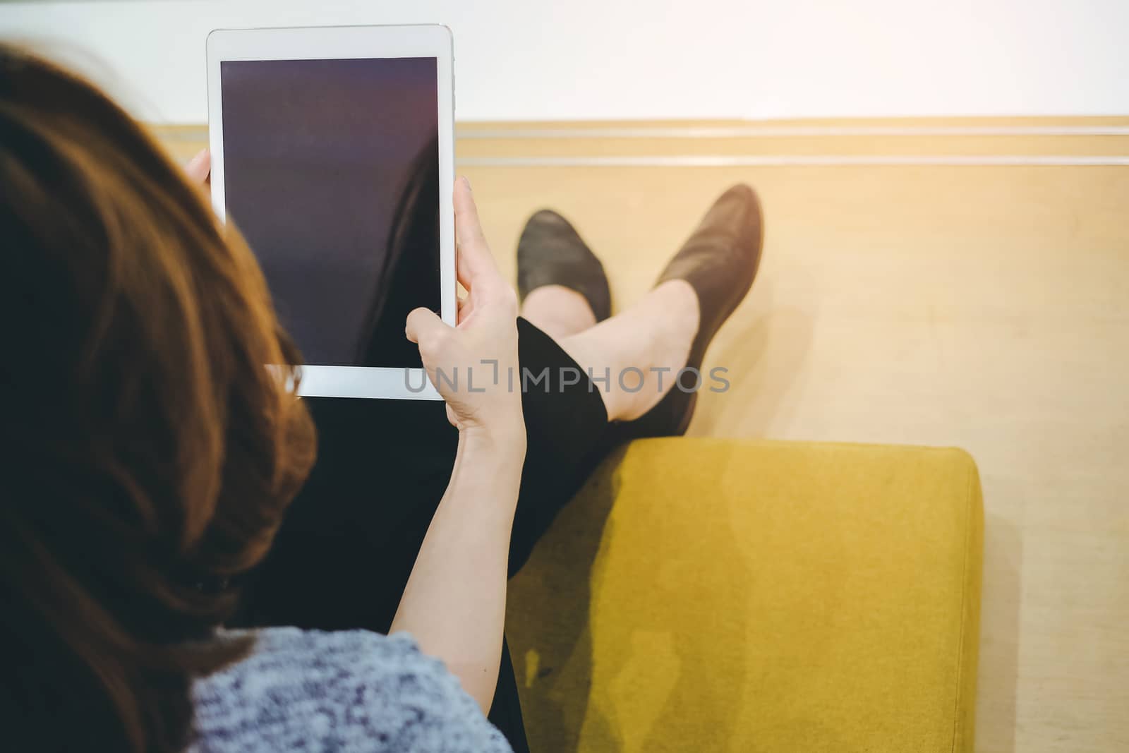 Top view of Young asian woman using tablet in modern office or shopping mall