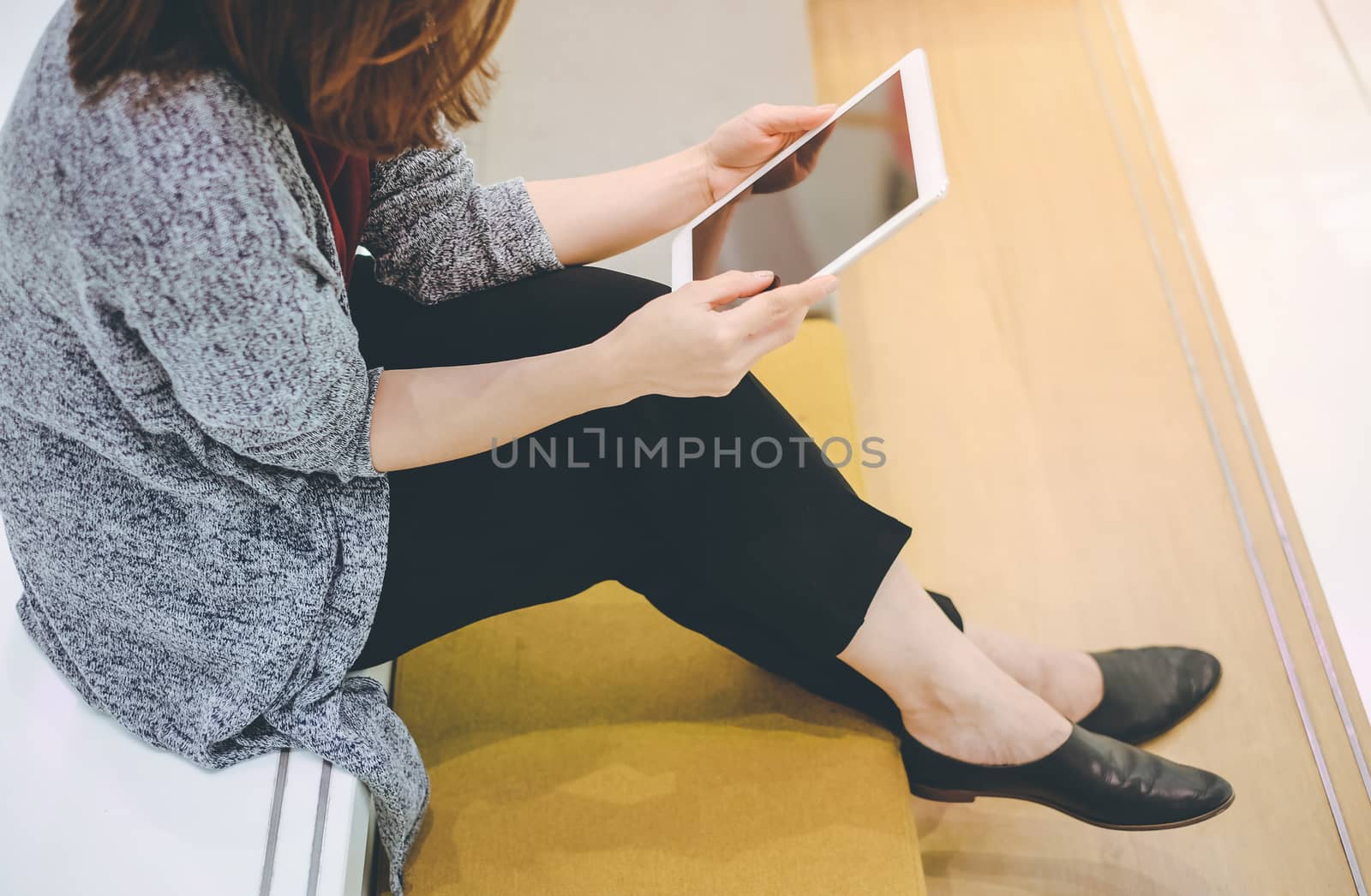 Young asian woman enjoy using tablet in modern office or shoppin by nuchylee