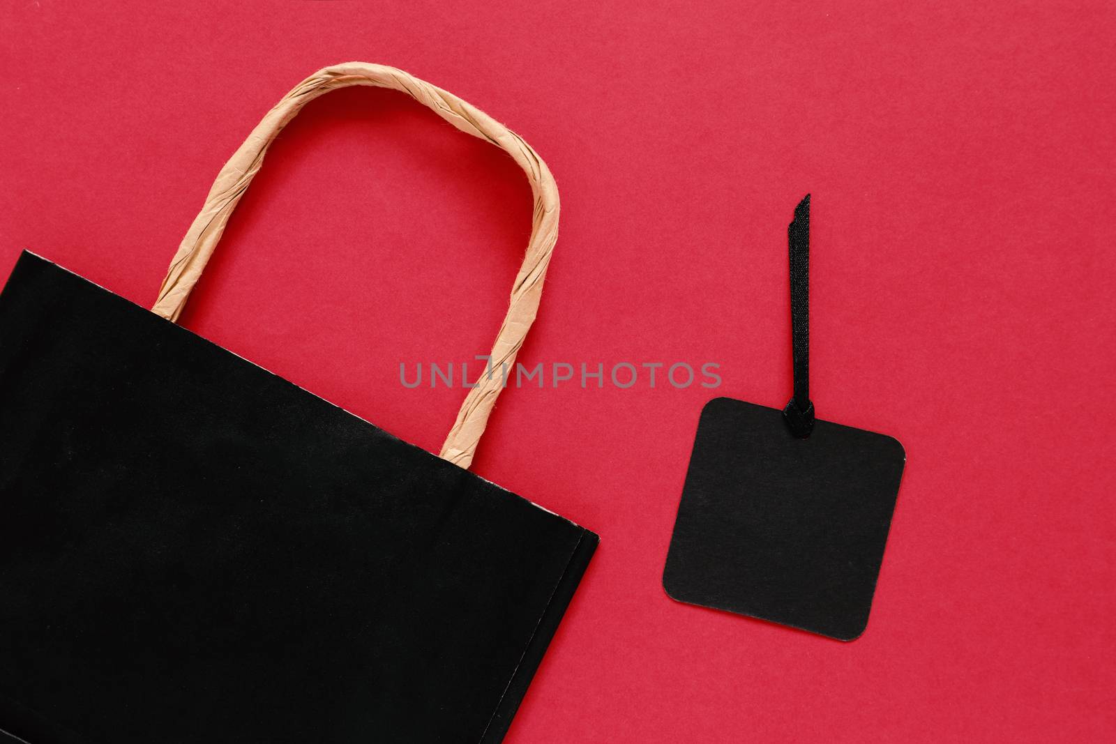 Mock up pf shopping bag with blank sale tag on red background, copy space,  shopping concept