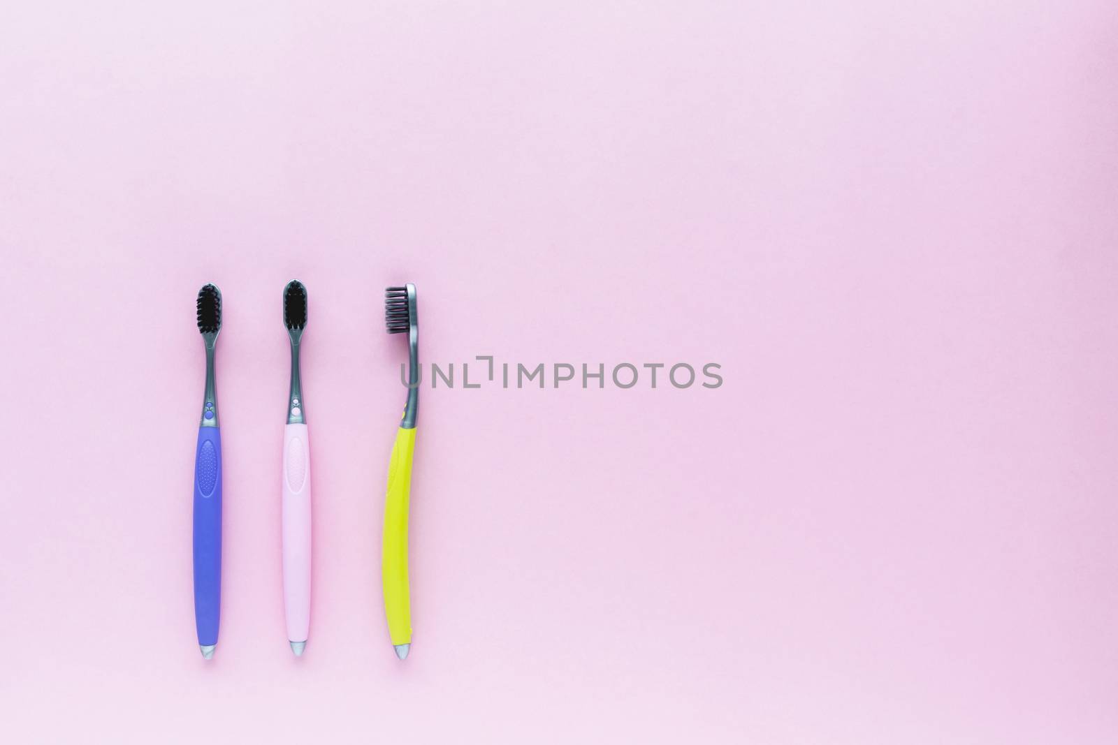 Set of toothbrush on pink background for dental care concept