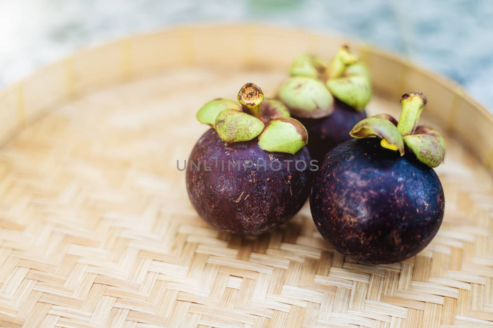 Mangosteen fruit on the wooden tray for food and eating concept