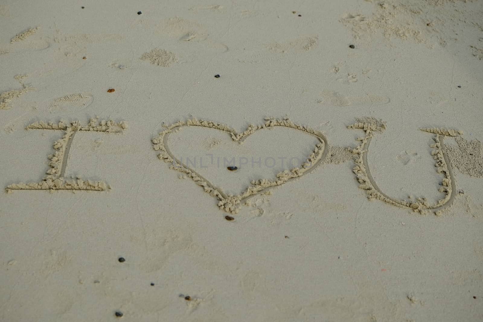 Word "I Love You" on sandy beach by iamnoonmai