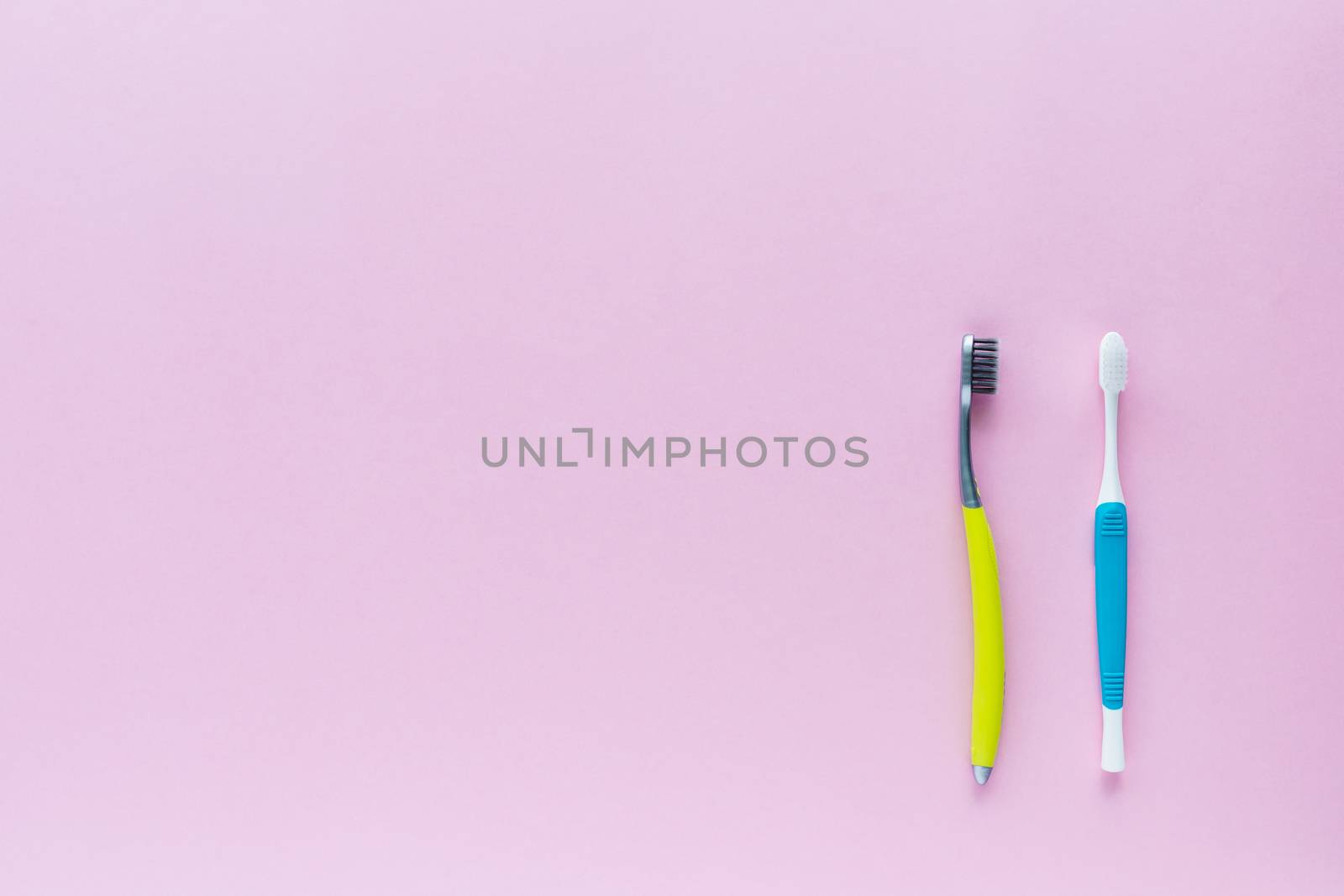 Toothbrush on pink background by iamnoonmai