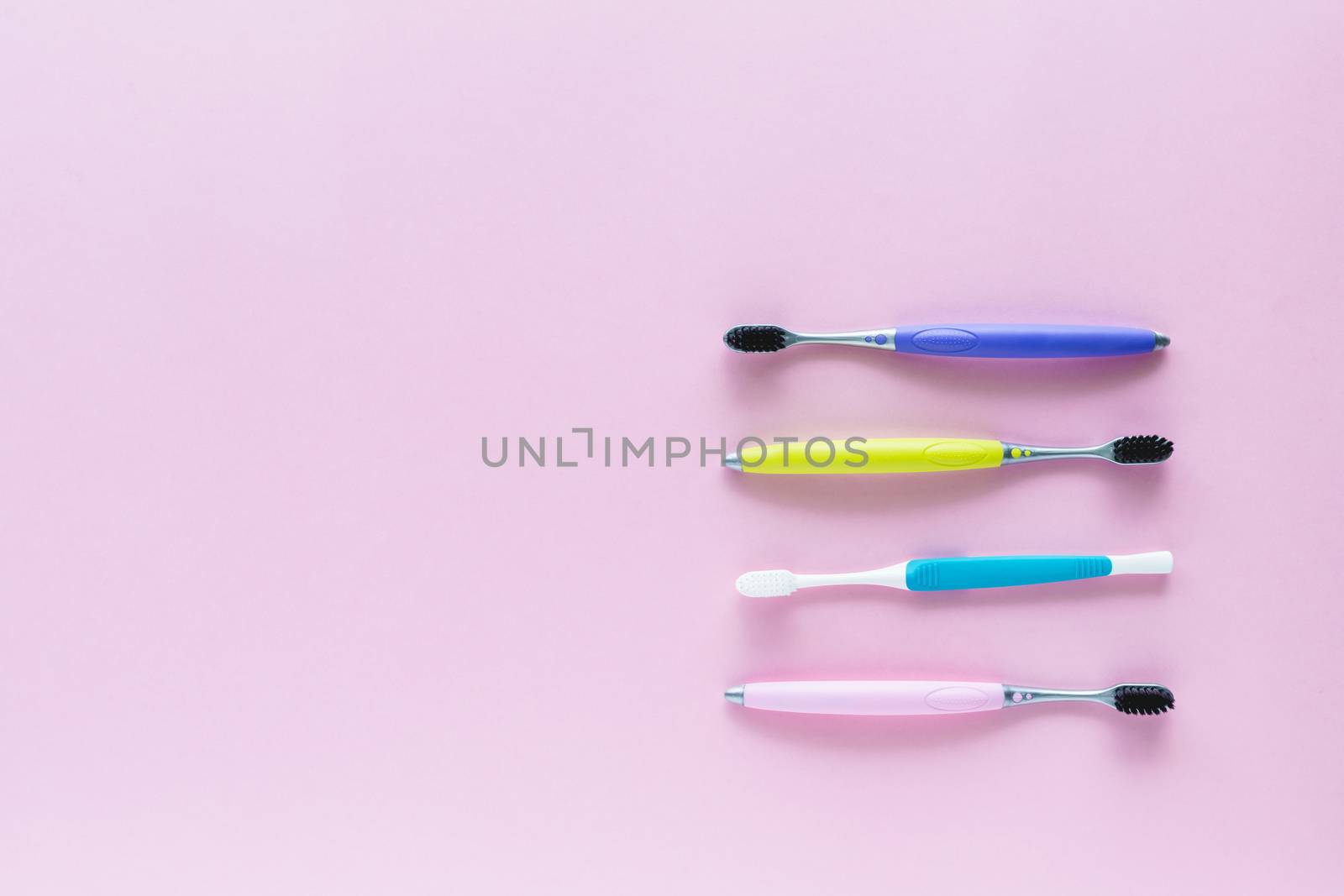 Set of toothbrush on pink background for dental care concept