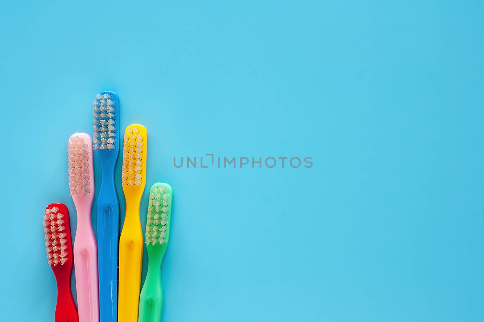 Toothbrush used for cleaning the teeth on blue background for dental care concept