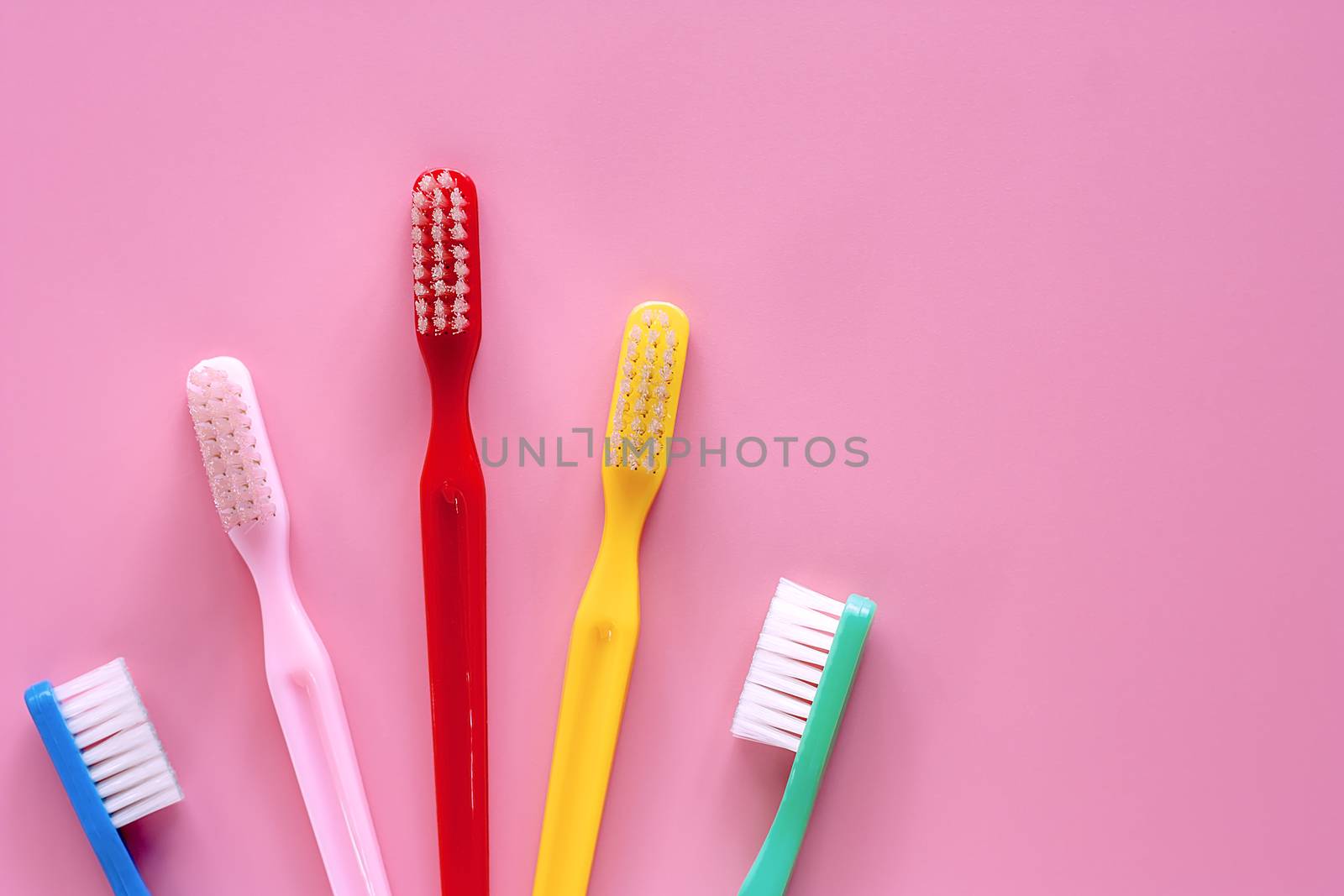 Toothbrush used for cleaning the teeth on pink background by iamnoonmai