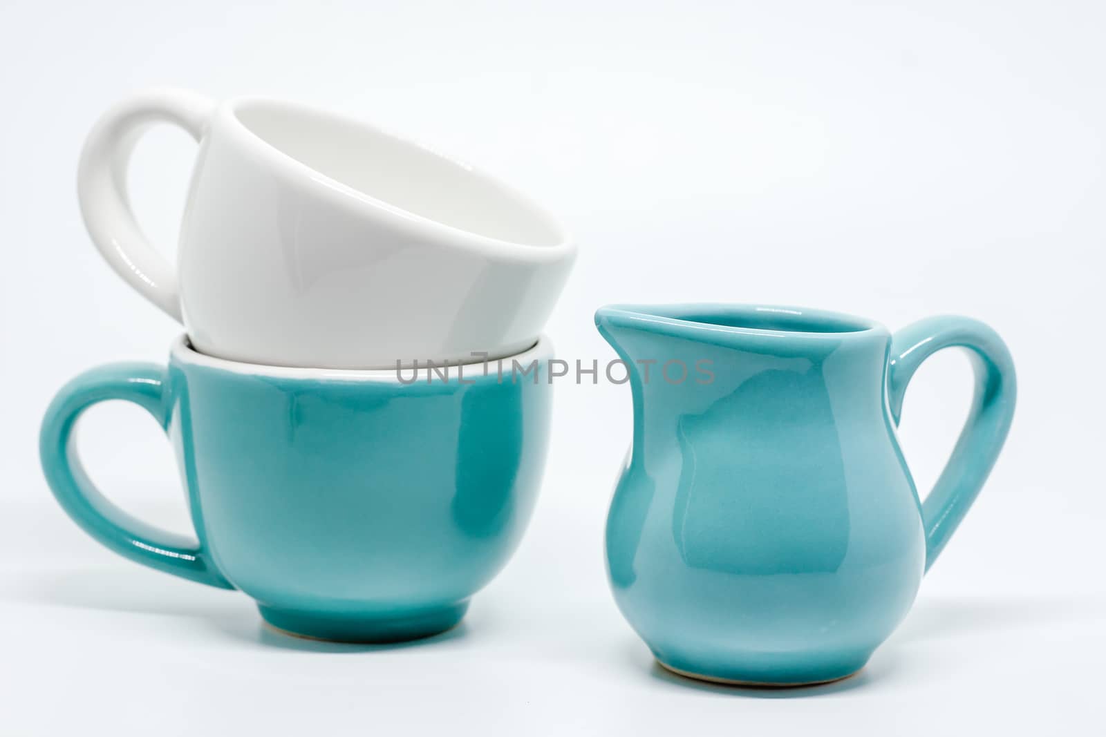 Two ceramic cup and pitcher on white background for utensil and dishware concept