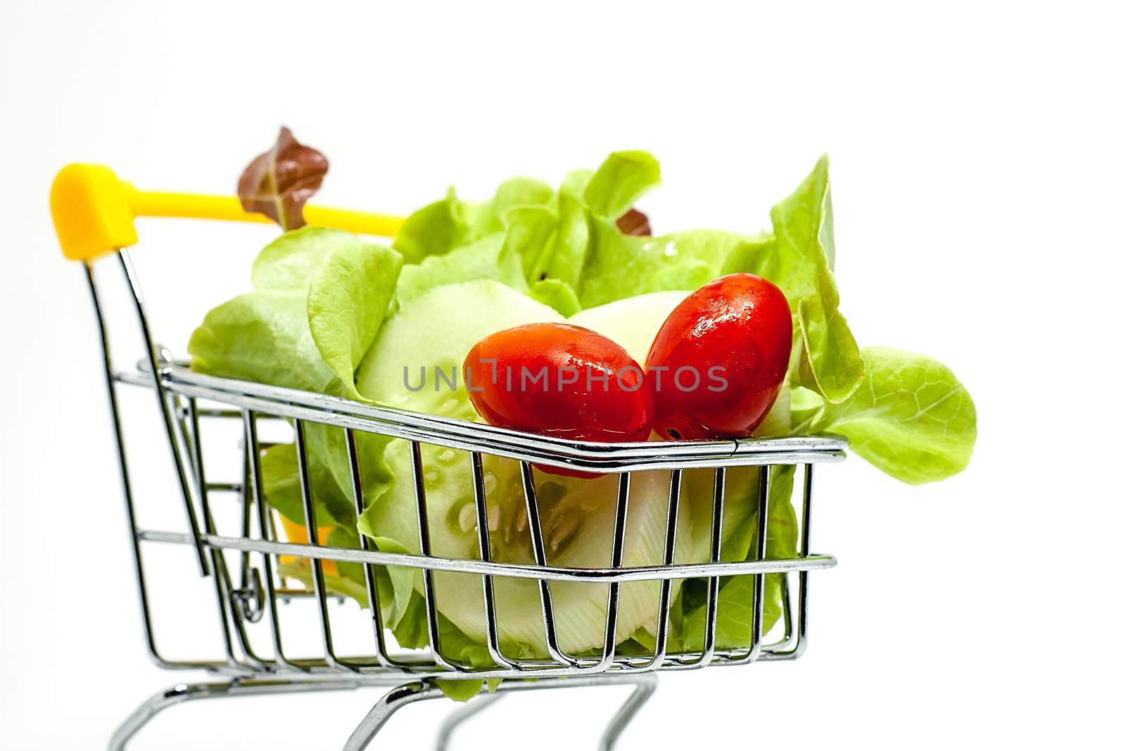 Fresh vegetables in the shopping cart on white background for healthy food concept
