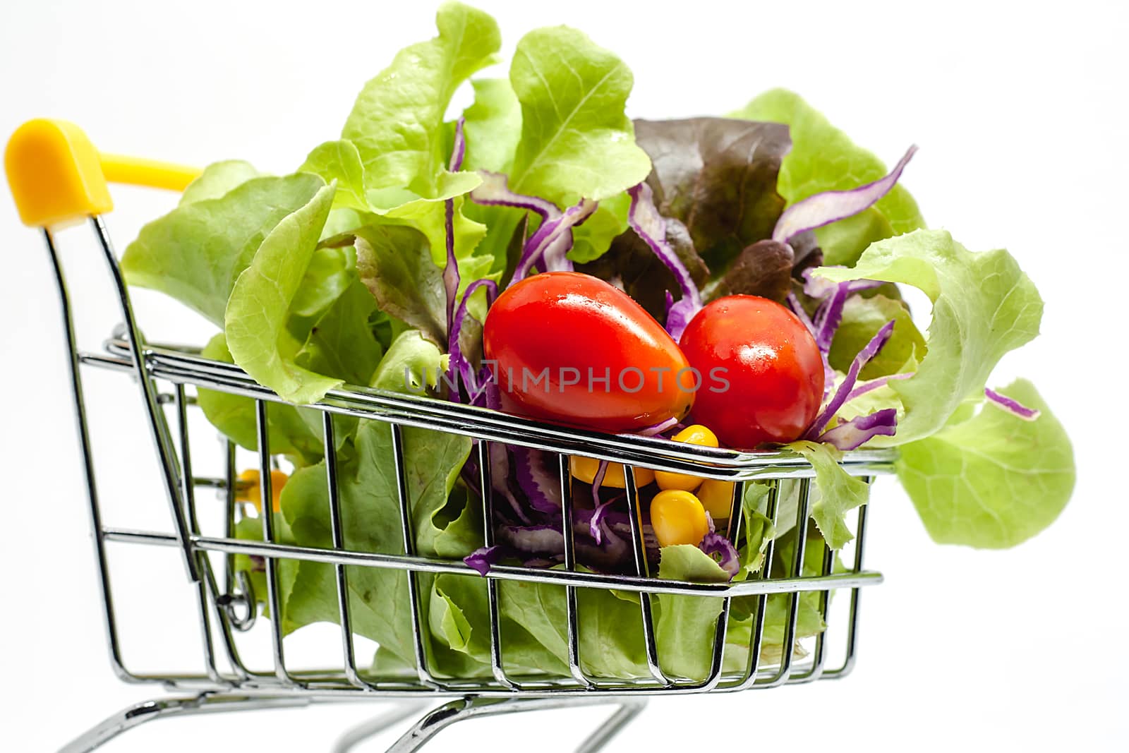 Vegetables in the shopping cart on white background for healthy food concept