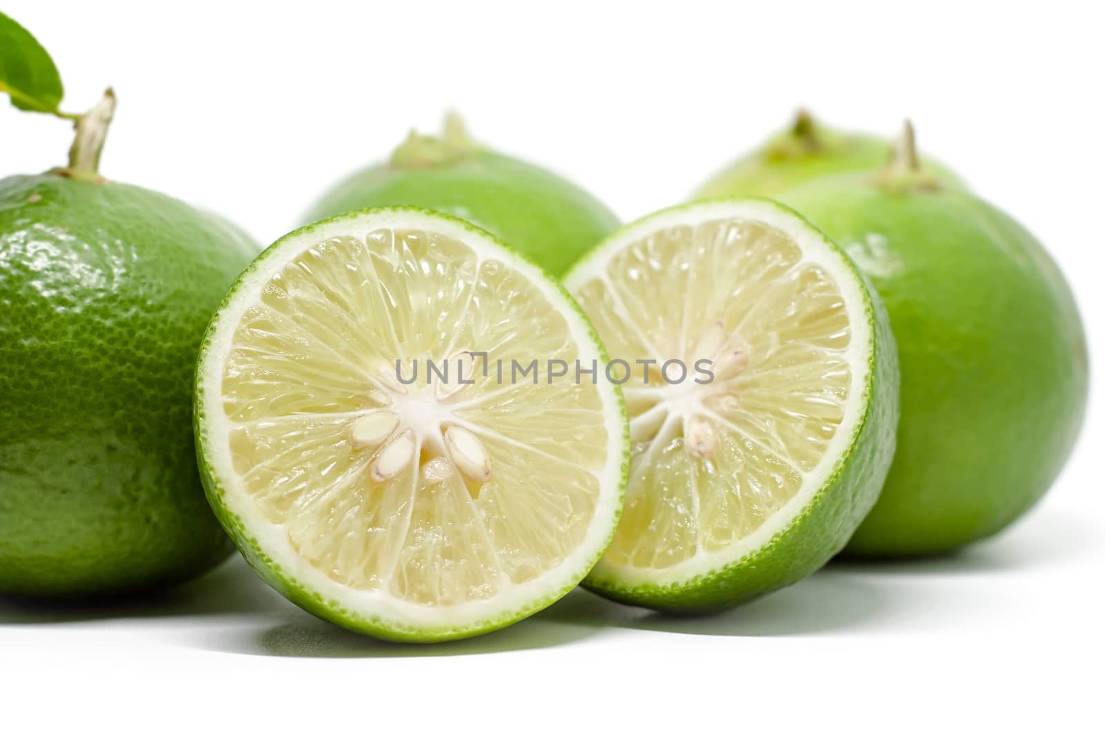 Green lime on white background for food ingredients and cooking concept