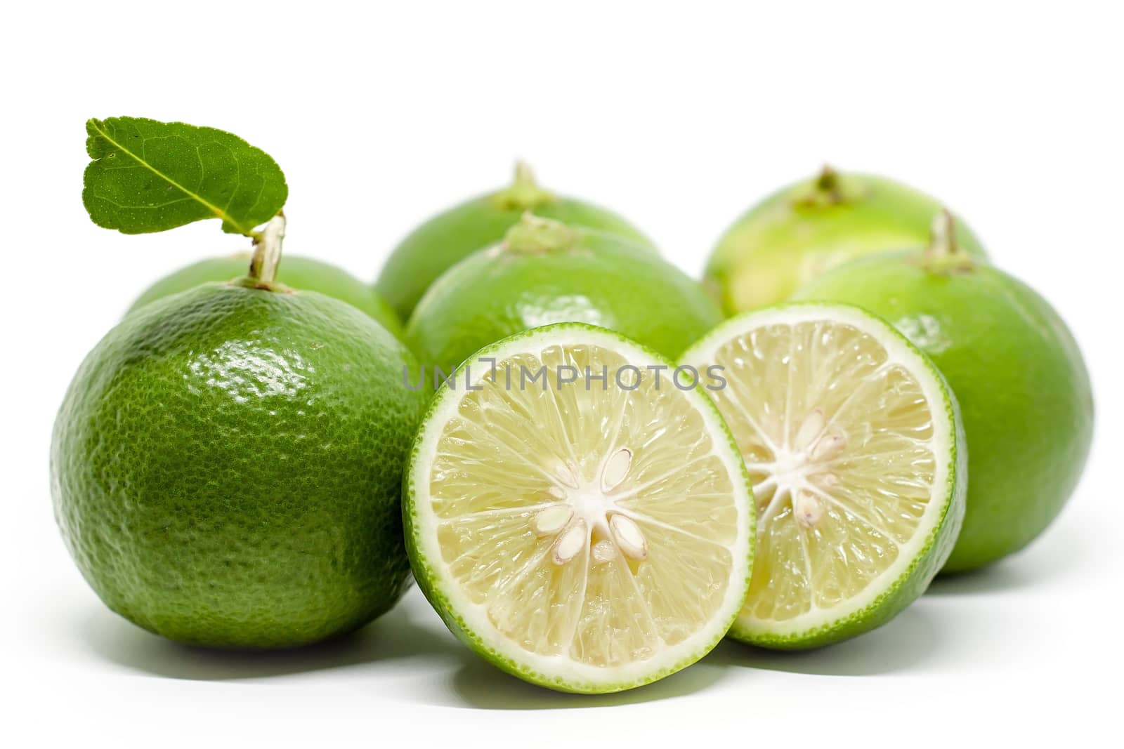 Green lime on white background for food ingredients and cooking concept