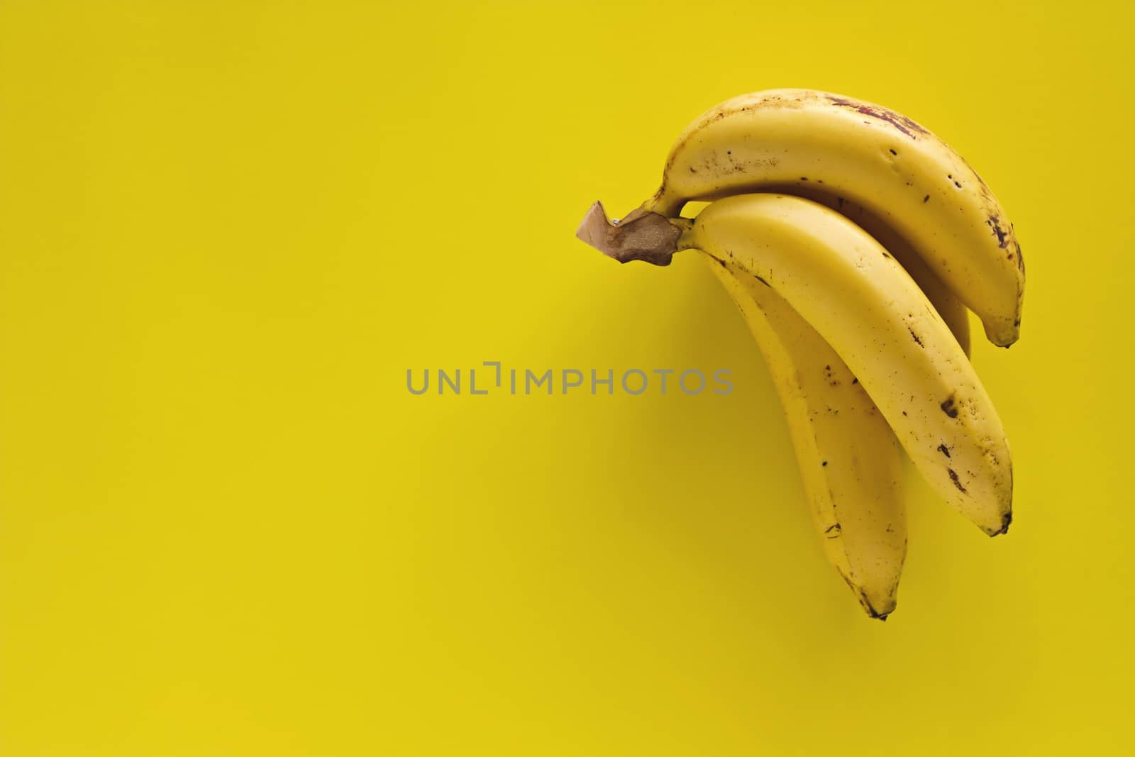 Bunch of bananas on yellow background for  eating healthy concept