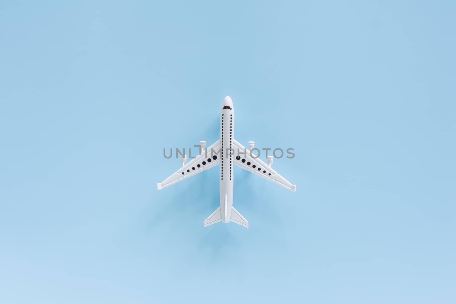 White airplane model on blue background for vehicle and transportation concept