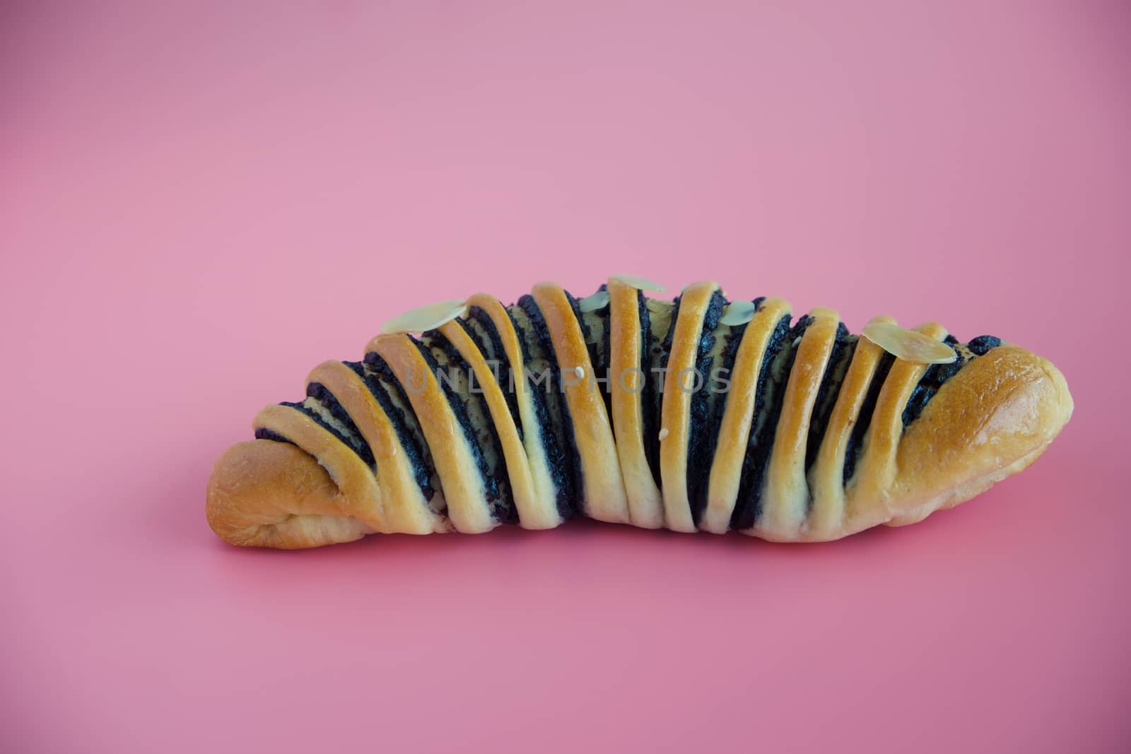 Delicious bread on pink background for food, bakery and eating concept