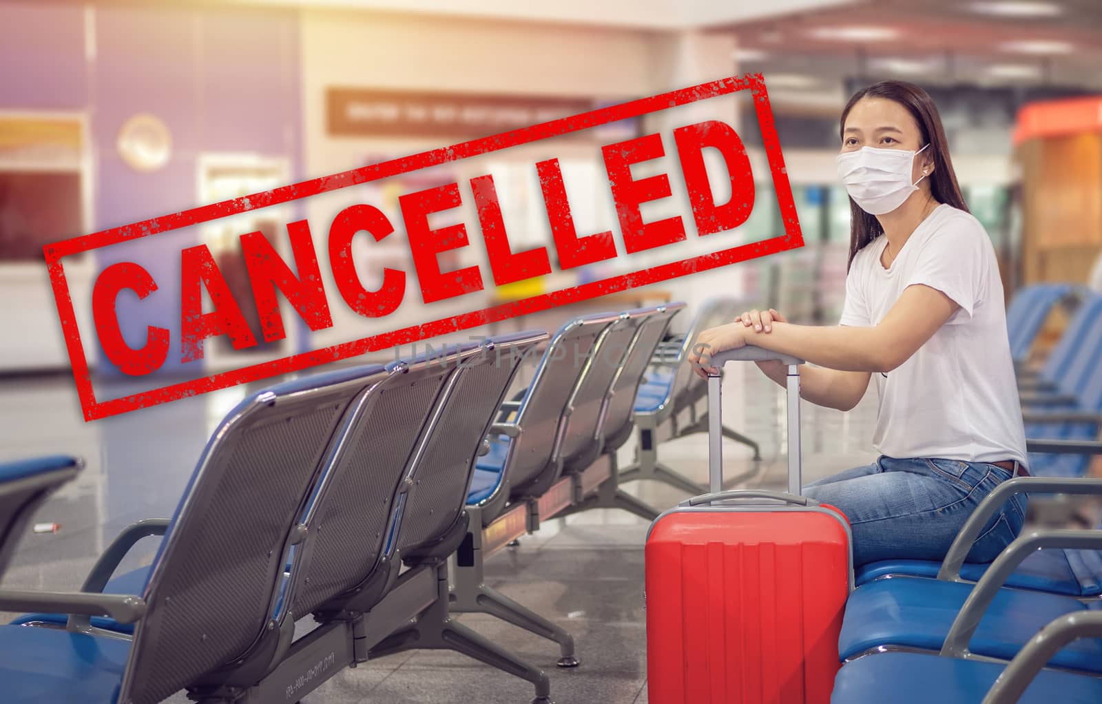 flight cancellation. Asian tourist with luggage ,wearing hygienic mask to prevent on travel time at the airport terminal for protect from Coronavirus 2019 (COVID-19) outbreak with text trip cancelled