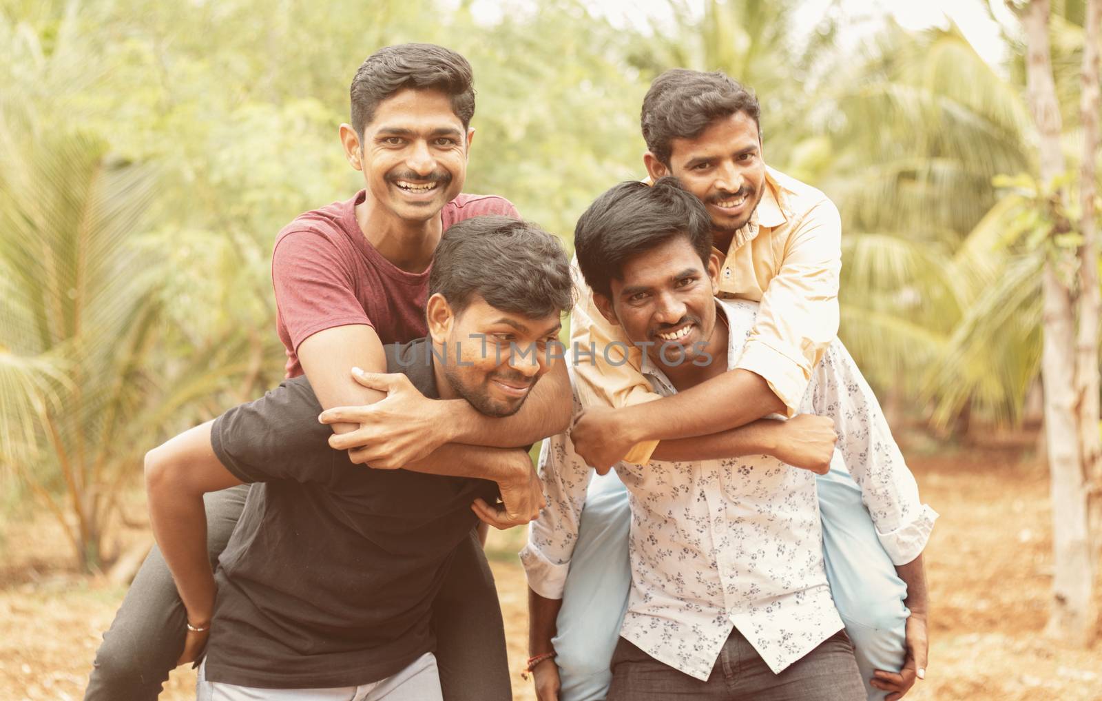 Best male friends Piggyback - Group Of Friends Having Fun Together Outdoors - Cheerful young male friends enjoying time together
