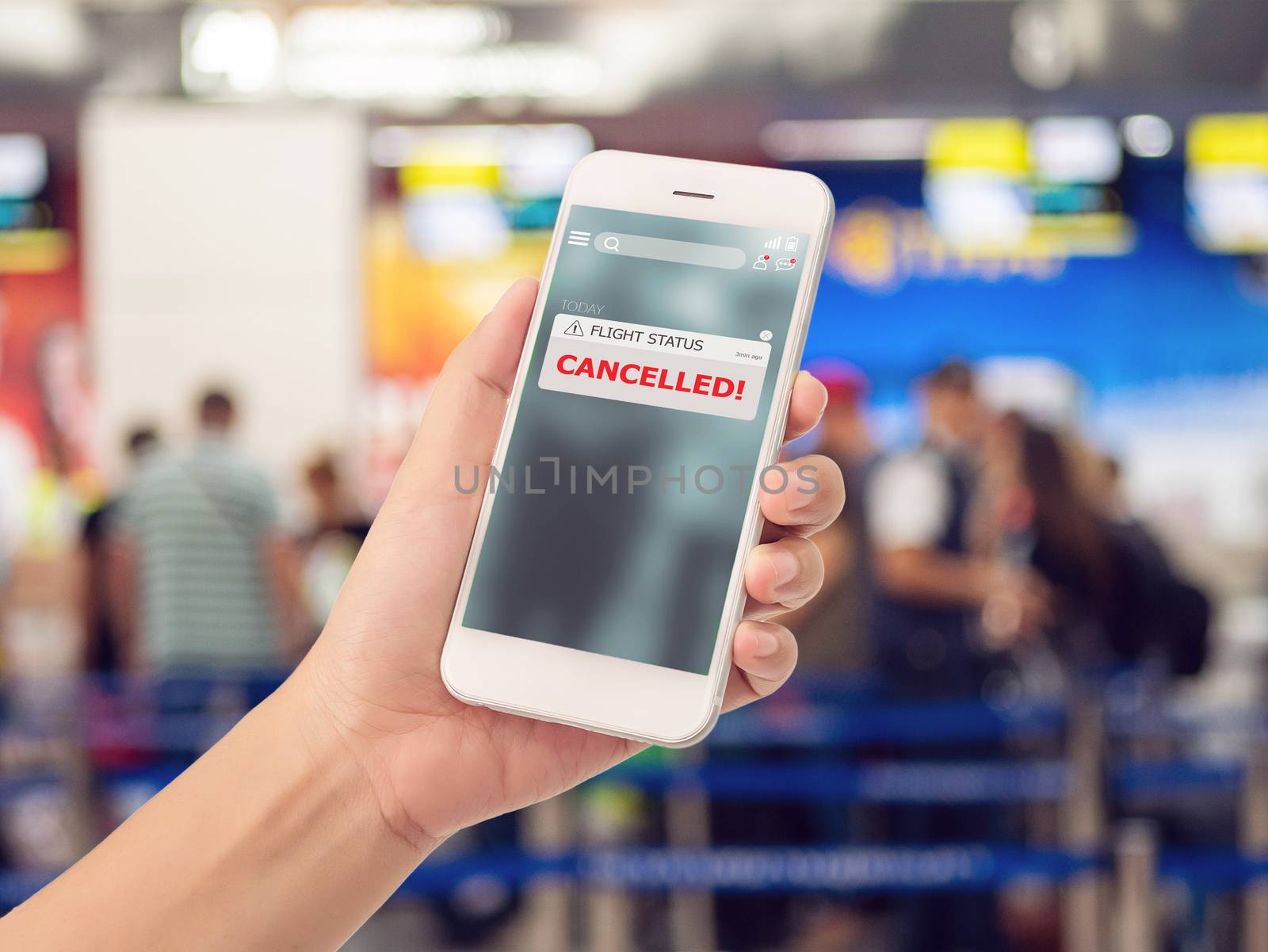 flight cancellation concept. announces message for flight schedule change information alert on smartphone application with check-in counter at airport terminal for background.