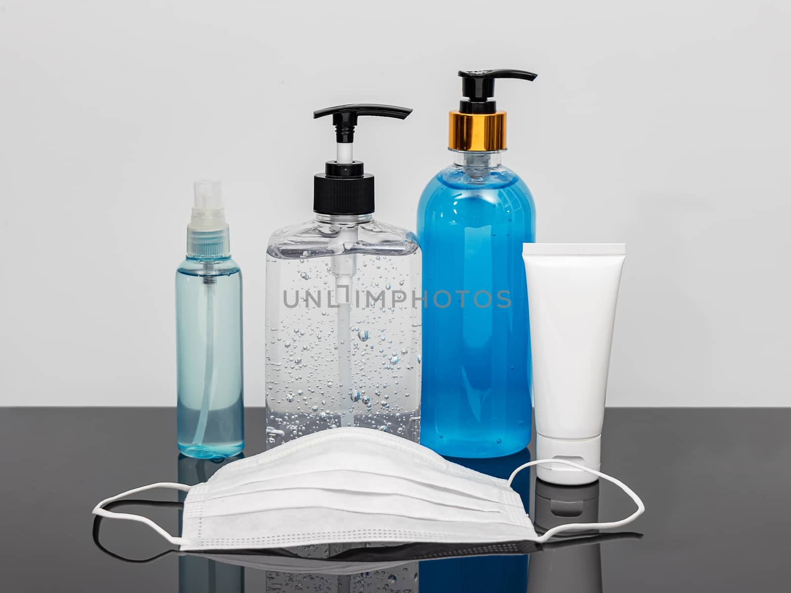 cleaning product such as hand sanitizer alcohol gel , portable alcohol spray , alcohol gel in a pump bottle , hygienic mask for disinfection, prevent spreading of germs during infections of COVID-19