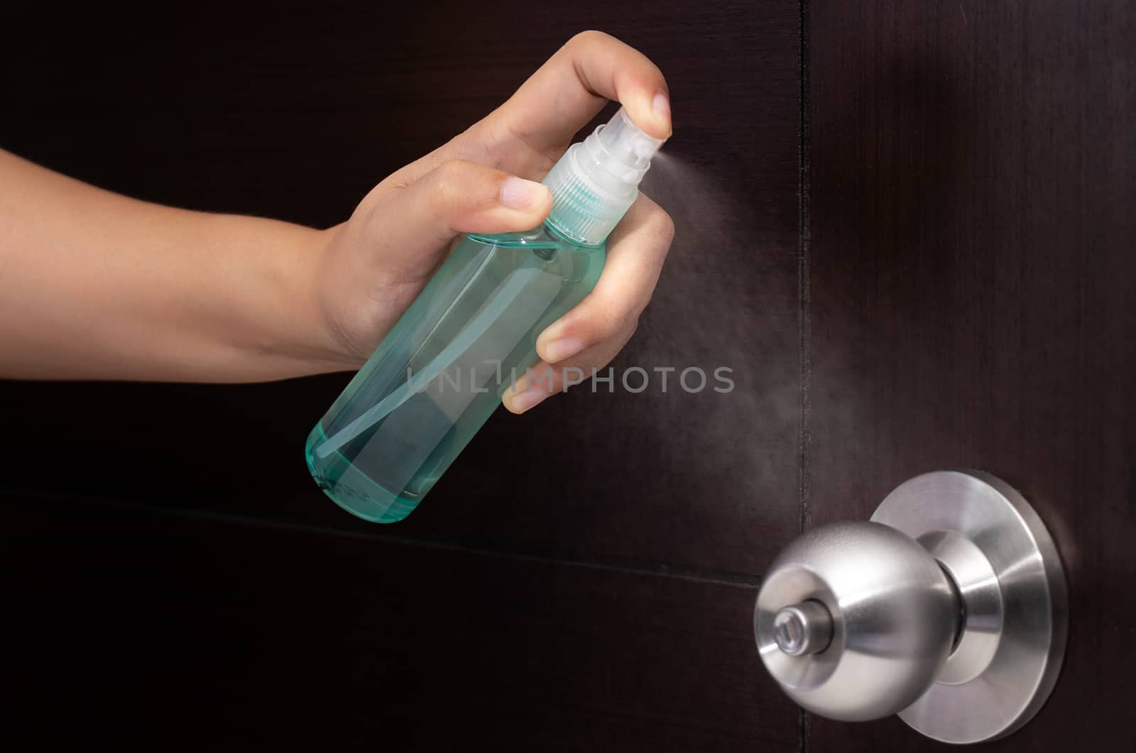 disinfect, sanitize, hygiene care. inject alcohol spray on door knob and frequently touched area for cleaning and disinfection, prevention of germs spreading during infections of COVID-19 coronavirus