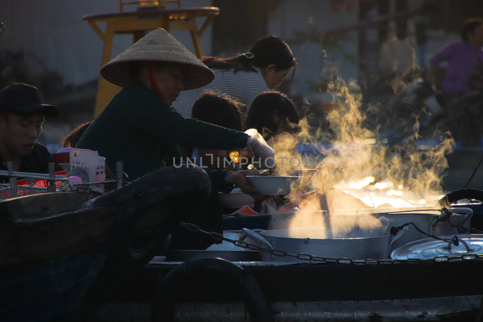 Editorial. Food vendors selling Vietnamese noodle soups in small wooden boats in the famous traditional Cai Rang Floating Market in Can tho, Vietnam