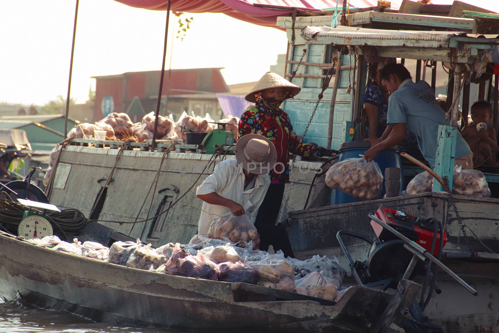 Editorial. Merchants selling fresh produce in Cai Rang Floating Market in Can tho, Vietnam