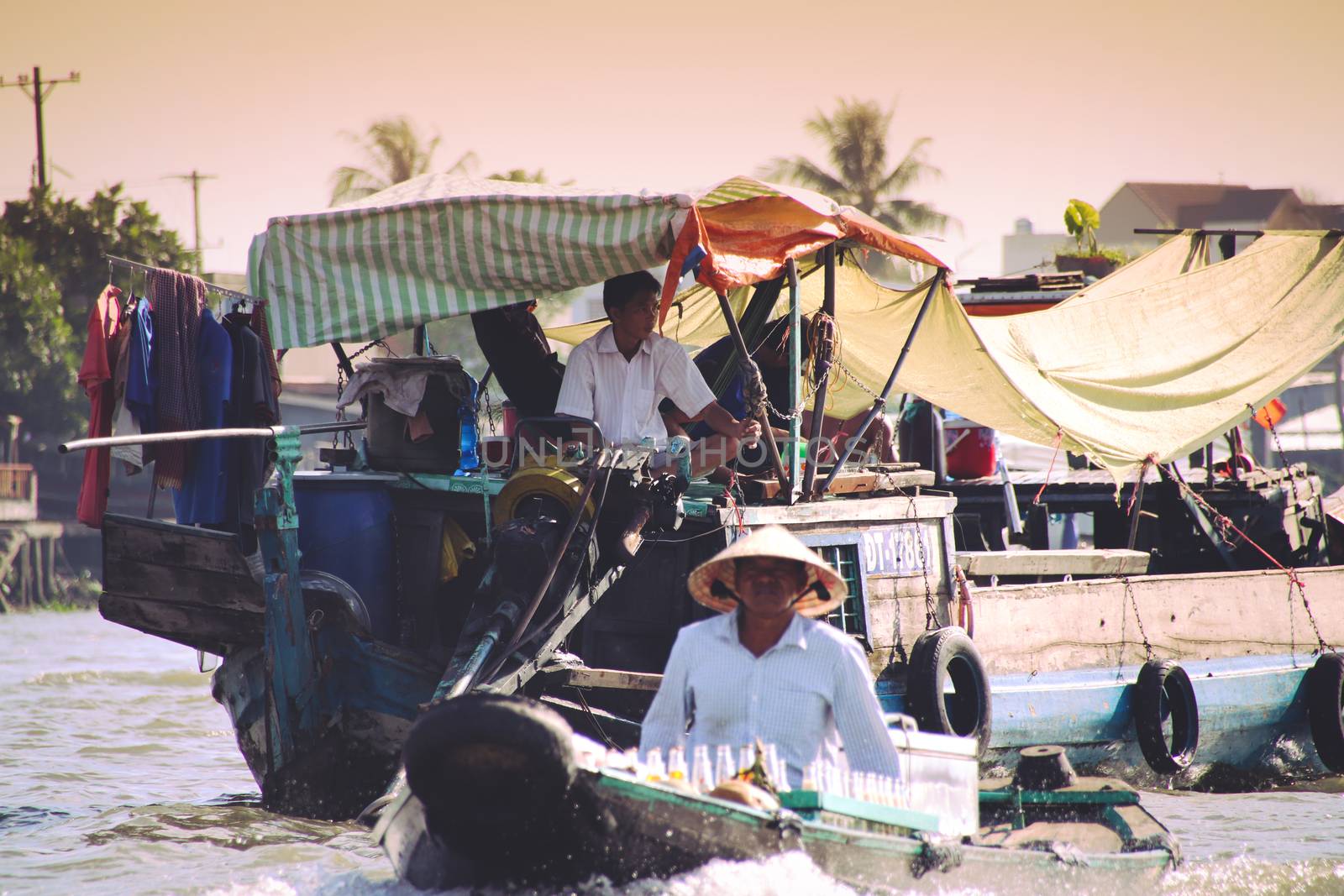 Editorial. Food vendors selling Vietnamese noodle soups in small wooden boats by Sonnet15