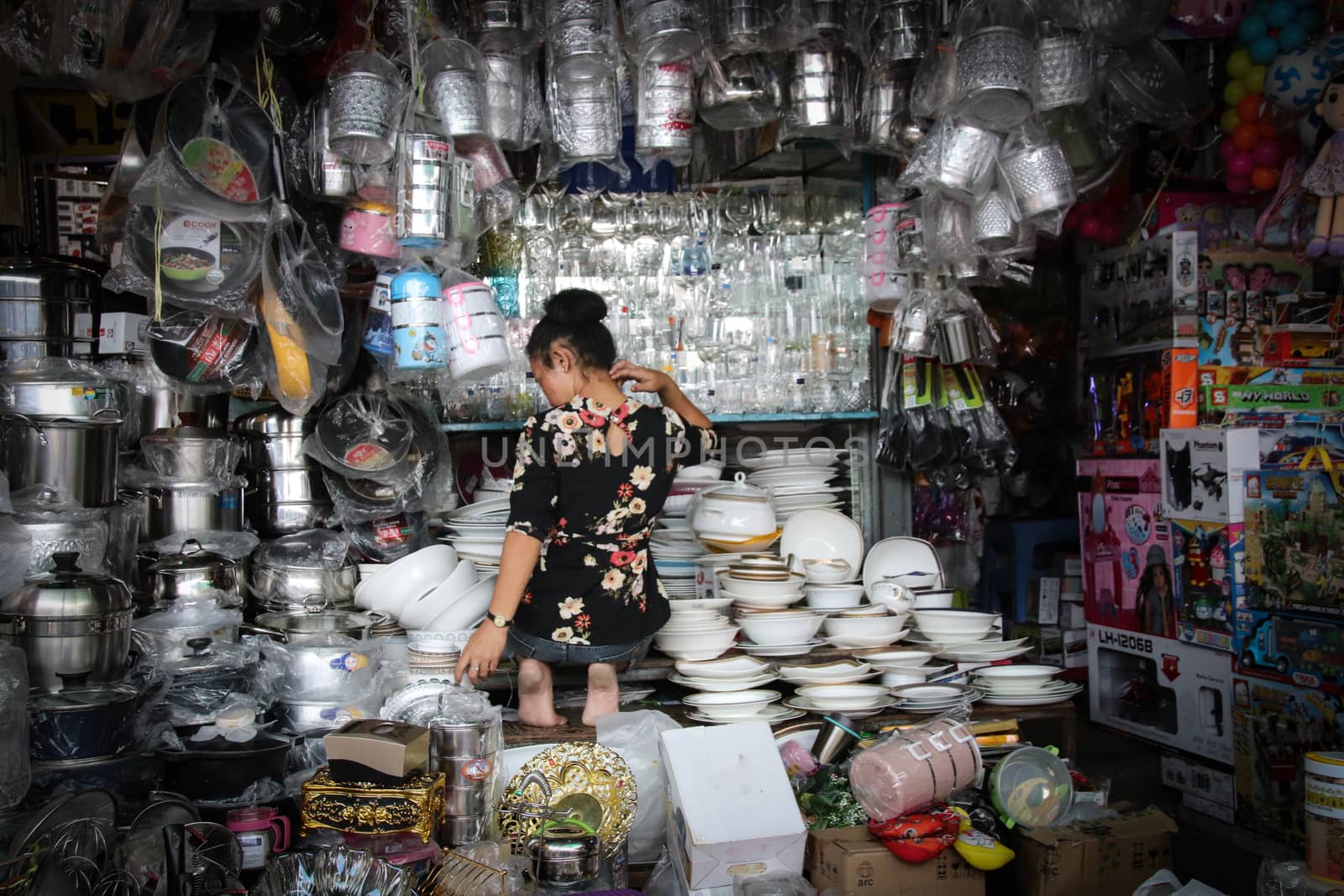 Editorial. A Cambodian woman sitting in her crowded market stall in Phnom Pehn Cambodia