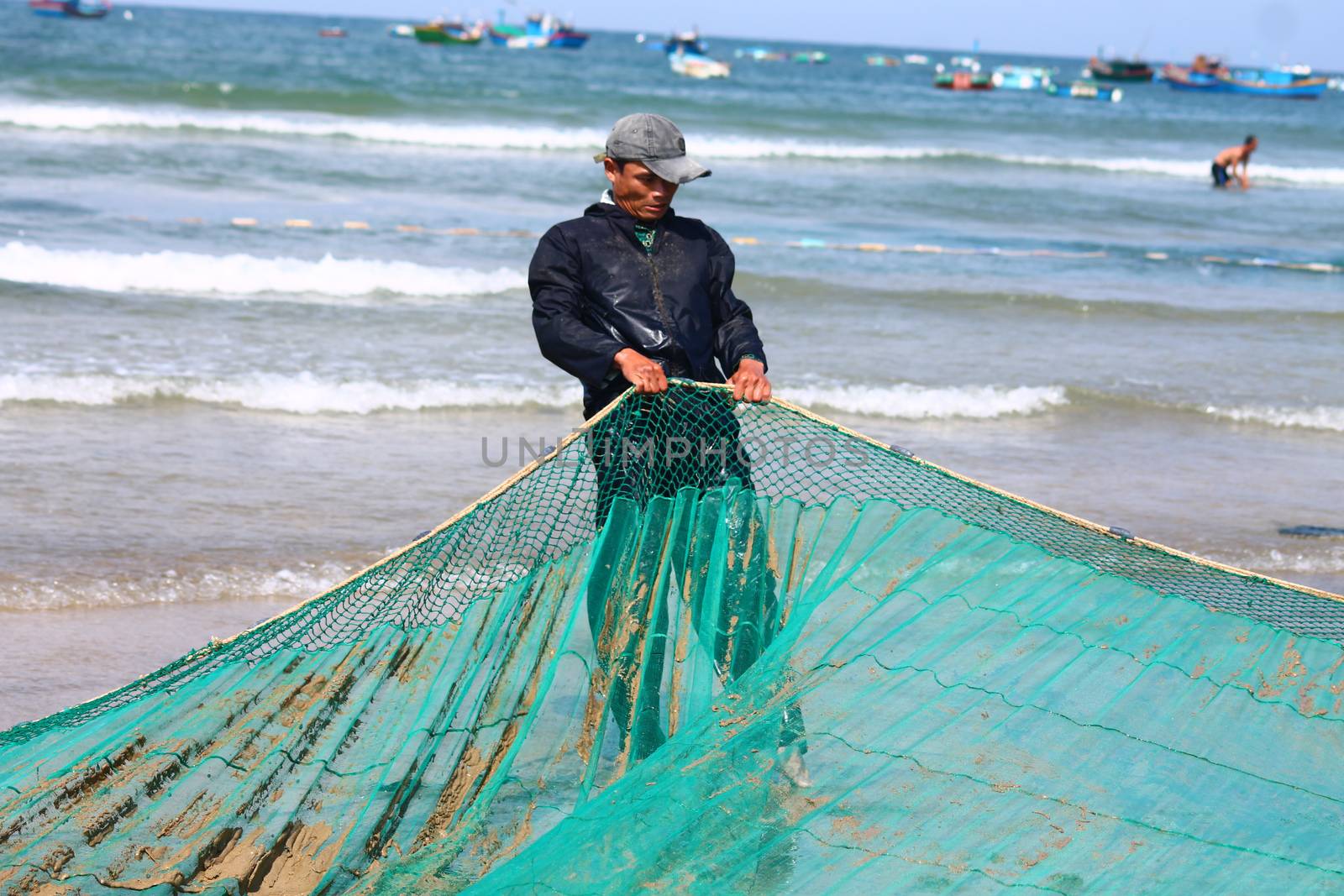 Editorial. A Vietnamese Fisherman Pulling a Fishing Net by Sonnet15