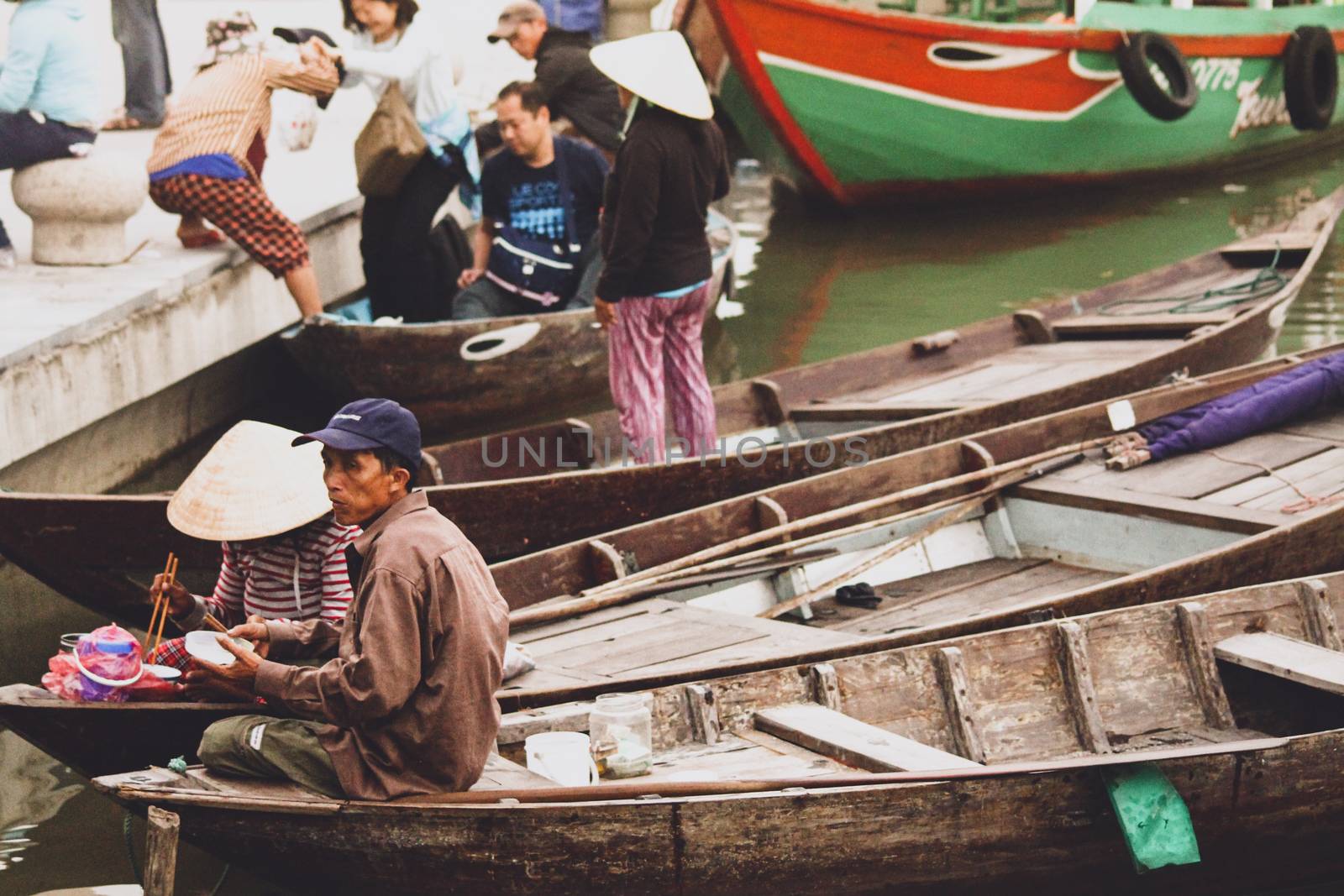 Editorial. Boat tour operators waiting for tourist in the ancient town of Hoi an, Vietnam