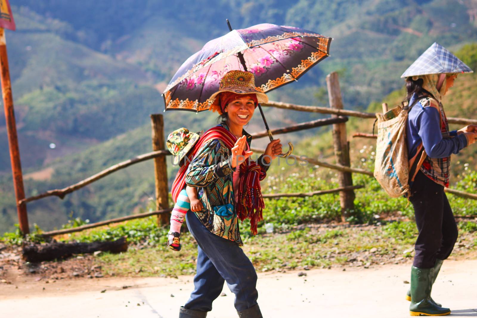 Editorial. Vietnamese women farmer walking back home from a full day of working in the Central Highlands of Vietnam