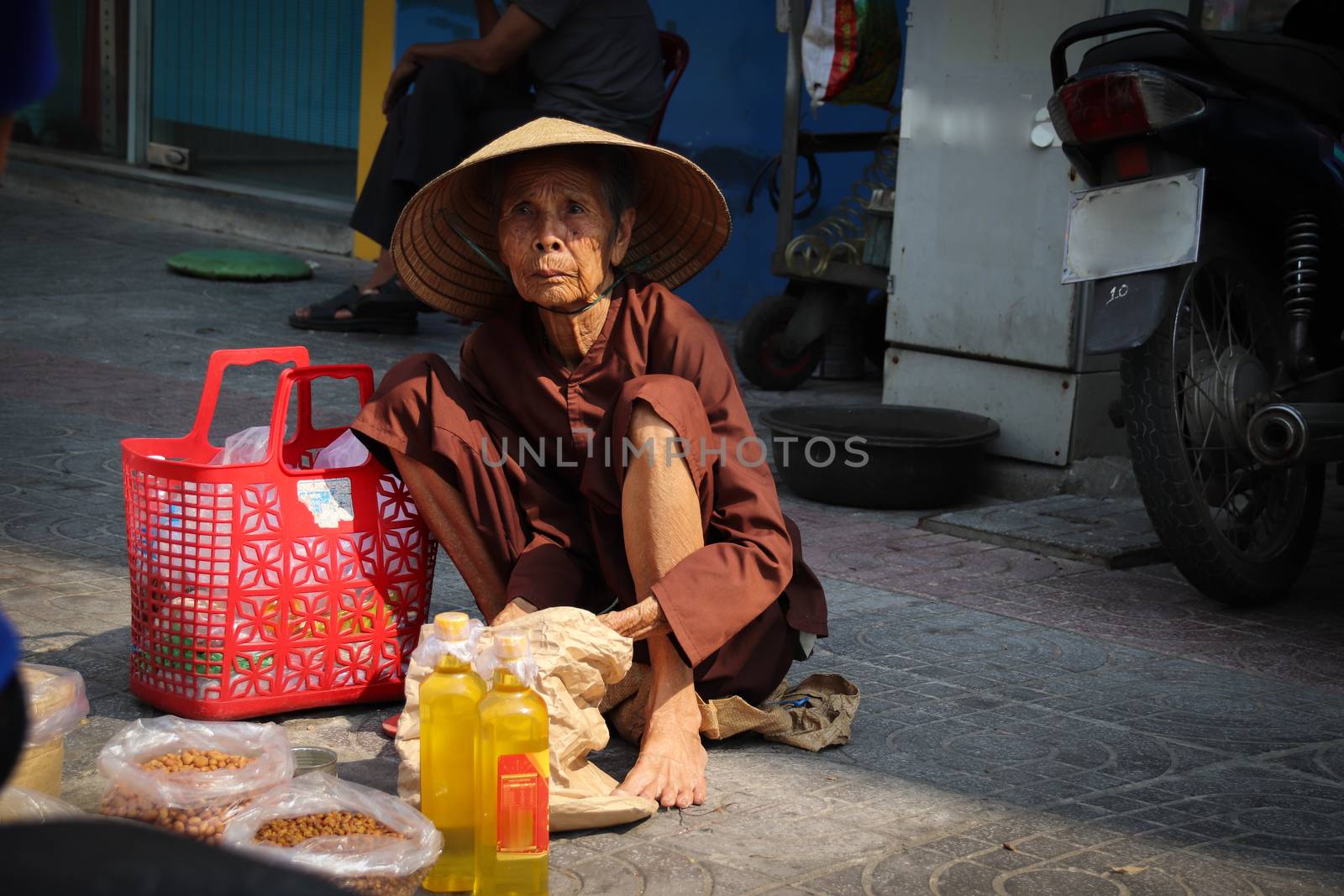 Editorial. An Old Vietnamese Grandma selling food on the streets of Hanoi City, Vietnam