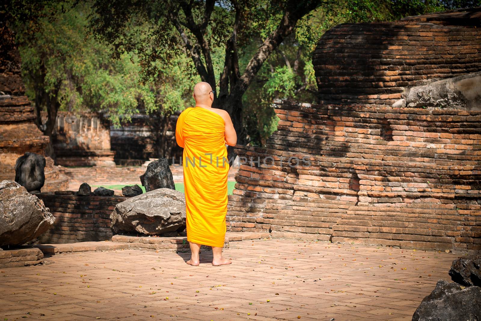 Editorial use only. A Thai Buddhist monk walking around Ayutthaya Historic Park by Sonnet15