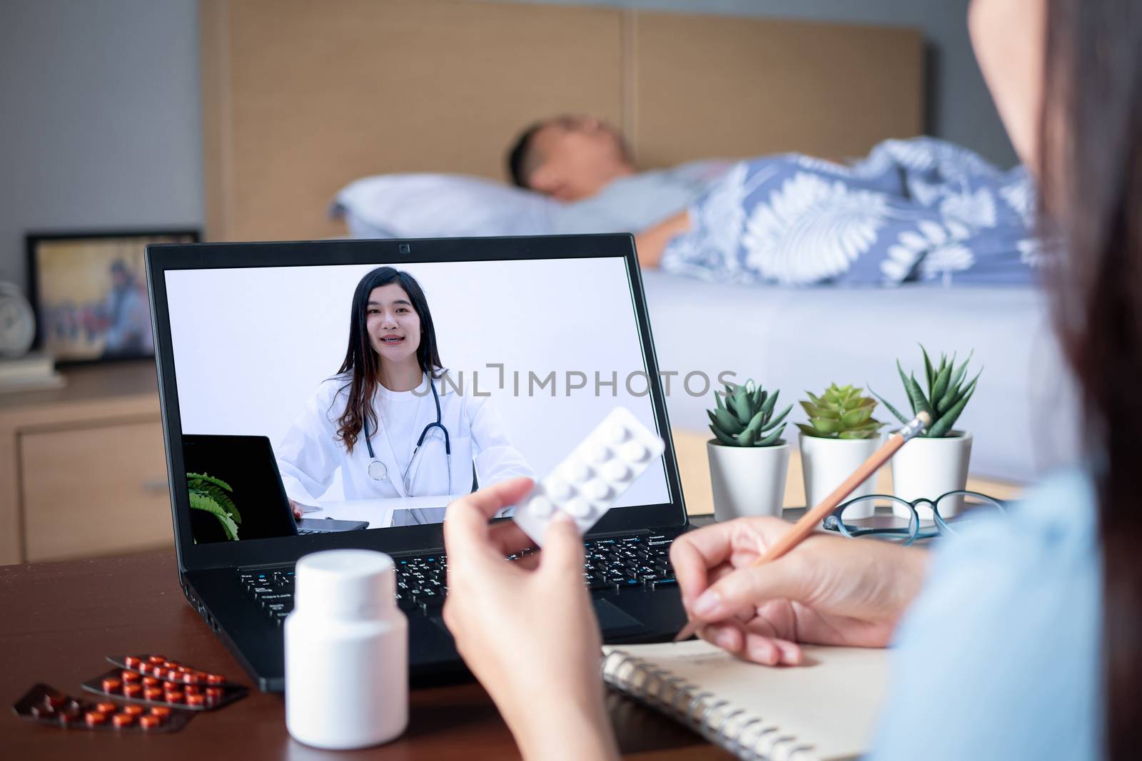 Patient's relatives use video conference, make online consultation with doctor on notebook computer, ask doctor about illness , medication via video call. Telehealth, Telemedicine and online hospital