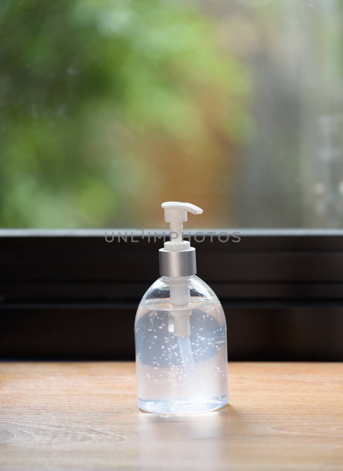 White bottles of sanitizer or liquid soap for hand hygiene to protect from corona virus on wood table.