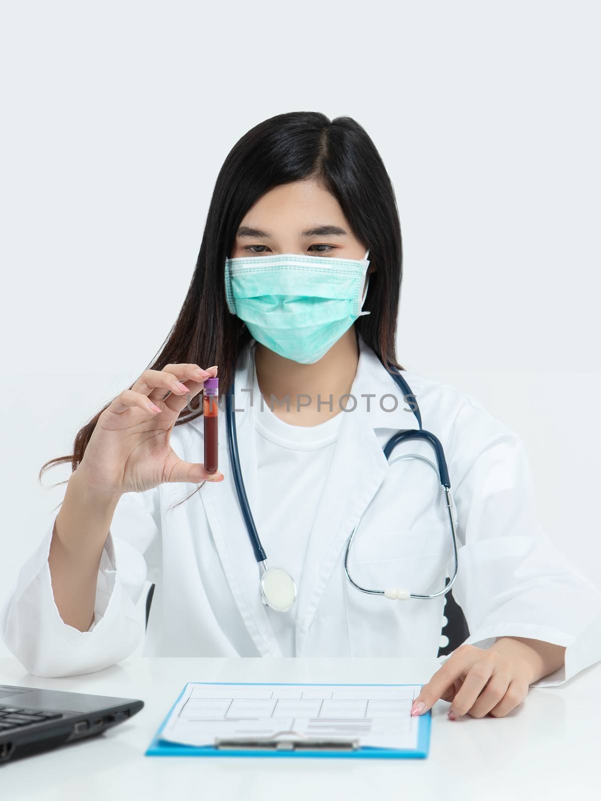 Asian doctor holding test tube with blood sample for covid-19 an by asiandelight