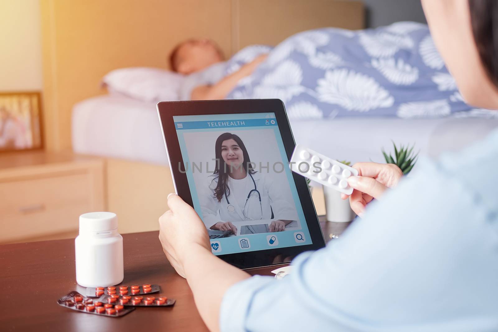 Patient's relatives use video conference, make online consultation with doctor on mobile application, ask doctor about illness , medication via video call. Telehealth, Telemedicine and online hospital