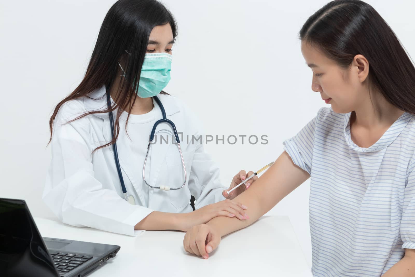 young Asian doctor woman wearing medical mask and stethoscope is by asiandelight