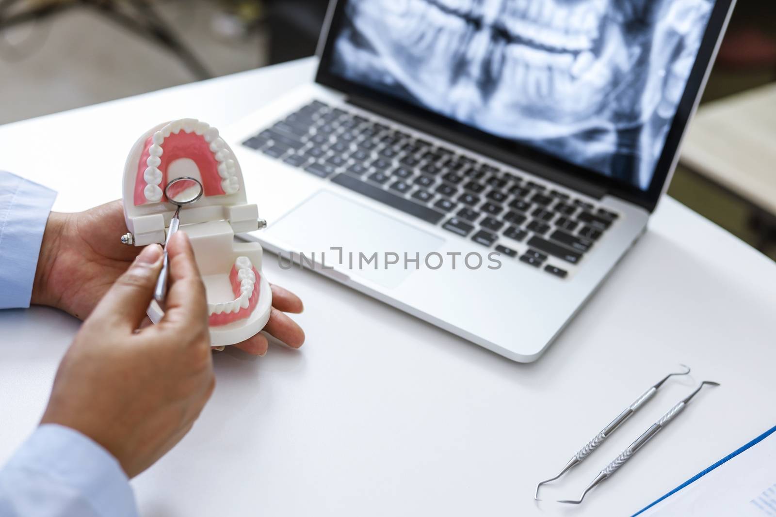 Dentist examining a patient teeth medical treatment at the denta by peandben