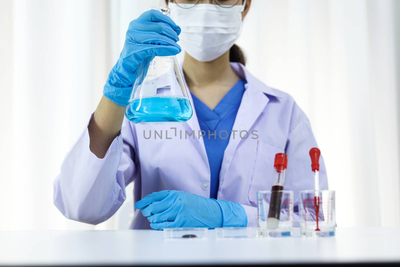 Scientist holding Coronavirus covid-19 infected blood sample tube. DNA testing of the blood in the laboratory with blood sample collection tubes and syringe Coronavirus Covid-19 vaccine research